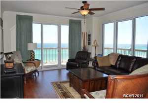 You'll enjoy the panoramic views of the Gulf Of Mexico from this extravagant Sunrise Beach unit. This is the best unit in the complex; not too high, not too low and has a wrap-a-round balcony for the best views on the beach. The interior of the unit features a split-bedroom floor plan and the seller added many upgrades including hand-sculpted wood flooring in the living room, 18-inch ceramic tile, and crown moulding. This unit also has a separate storage unit next to the elevators. Sunrise Beach offers its residents hundreds of feet of dedicated beach, covered parking garage under the building, on-site gym, two pools and hot tubs, and children's water play area. You're also walking distance to many restaurants and just a 3 minute drive to Pier Park. All info is approx and must be