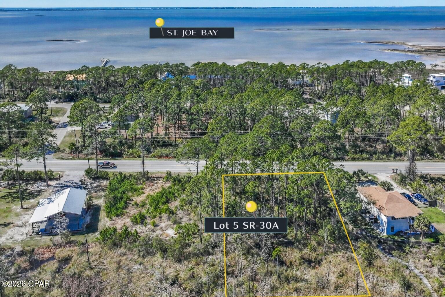 Ready to build your dream home near Cape San Blas? This level, wooded half-acre lot along SR 30A offers the best of both worlds -- easy access and peaceful coastal living. Imagine mornings under tall pines, afternoons kayaking or scalloping in the bay, and evenings watching Gulf sunsets just minutes away. Multiple boat ramps nearby make getting out on the water effortless. Salinas Park is right around the corner with pickleball courts, playground, picnic areas, fire pit, and scenic Gulf and Bay walkovers. Plus, the 14-mile Loggerhead Trail is perfect for biking and sunset strolls. Fresh seafood, live music, and shopping in Port St. Joe are just a short drive in any direction. Covenants and Restrictions apply. No RVs or mobile homes allowed. Listing agent related to Seller. Coastal dreams start here.