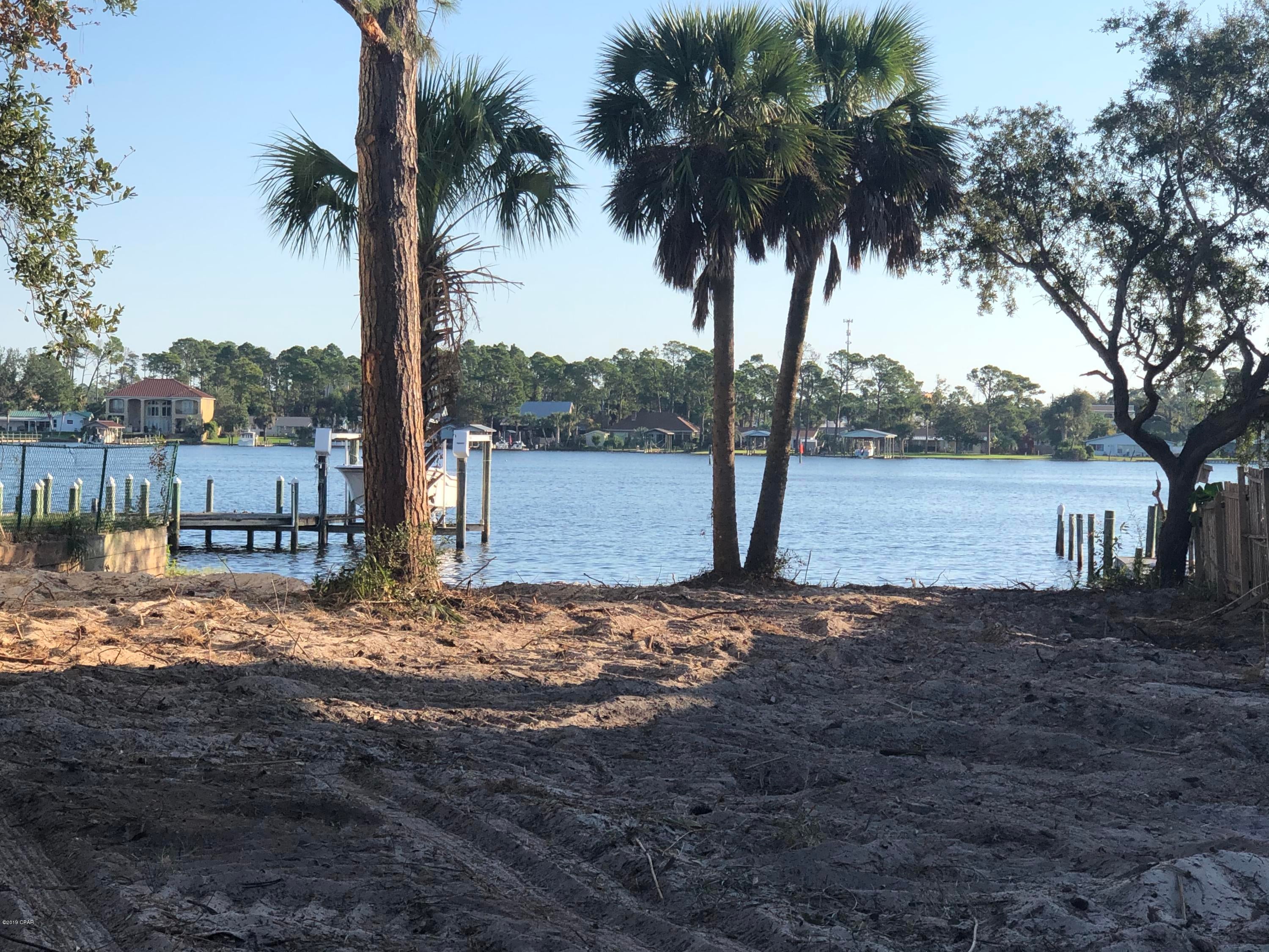 Awesome Views of the Lagoon from this waterfront property in Panama City Beach! Walk to the Dolphin Drive boat ramp. This lot is close to the beach and directly on Grand Lagoon.