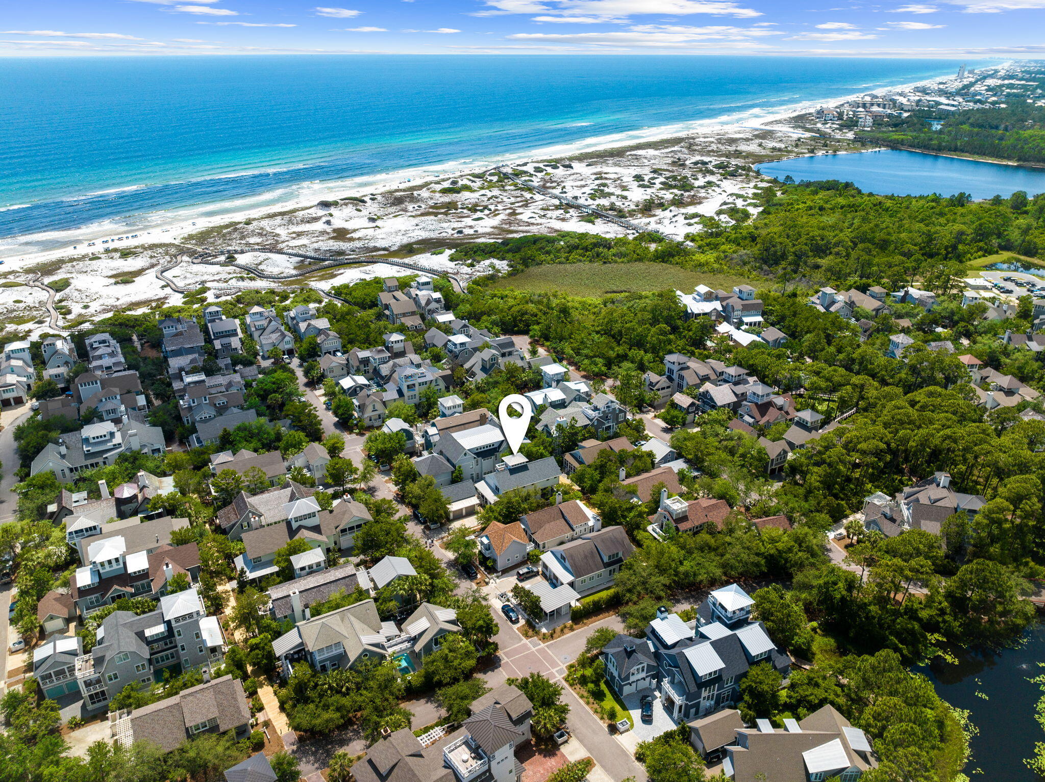 Rare WaterSound Beach opportunity!  Fresh to the market, this tranquil home is located in one of the most desirable enclaves of WaterSound Beach.  It has been recently remodeled from top to bottom including the addition of a secluded courtyard area with a refreshing splash pool which also functions as a relaxing hot tub.  Upon entry, take in the comforting sense of natural light, complemented by tastefully selected interior design elements.  You'll appreciate the solid tile walls that highlight the kitchen and bar area, the quality light fixtures that omit a beachy glow, and the solid hardwood floors that give the entire home an elegant and airy coastal feel. The floor plan flows beautifully for comfort and entertaining with the kitchen flowing naturally from the grilling area, through to the dining room and living areas that function as the heart of the home.  Enjoy opening the french doors stretching the length of the living room out to the large outdoor screen porch that overlooks the boardwalk.  A quick left onto the boardwalk will take you straight to the beach!  The owner suite is on the first floor and features a private screened porch overlooking the pool and private courtyard.  The owner's luxurious bathroom is styled with hand painted tiles, a soaking tub, and a lovely, spacious walk-in shower.  Upstairs features another well appointed secondary guest suite, as well as two other large guest bedrooms, each with their own en suite bath.  The landing offers a cozy sofa area with a TV for guests to lounge & a desk nook for quick correspondence from the beach.  The laundry room is extremely spacious and offers an abundance of storage opportunities.  Ascending to the third floor, you'll find a small tower with a lovely bar area that leads to a quaint balcony.  The home also features a two car garage that can house multiple golf carts, bikes, and vehicles - it also has recent AC and roof replacements for optimal energy efficiency.  The home comes fully furnished in such a way that warmly welcomes you to the beach and makes you never want to leave!