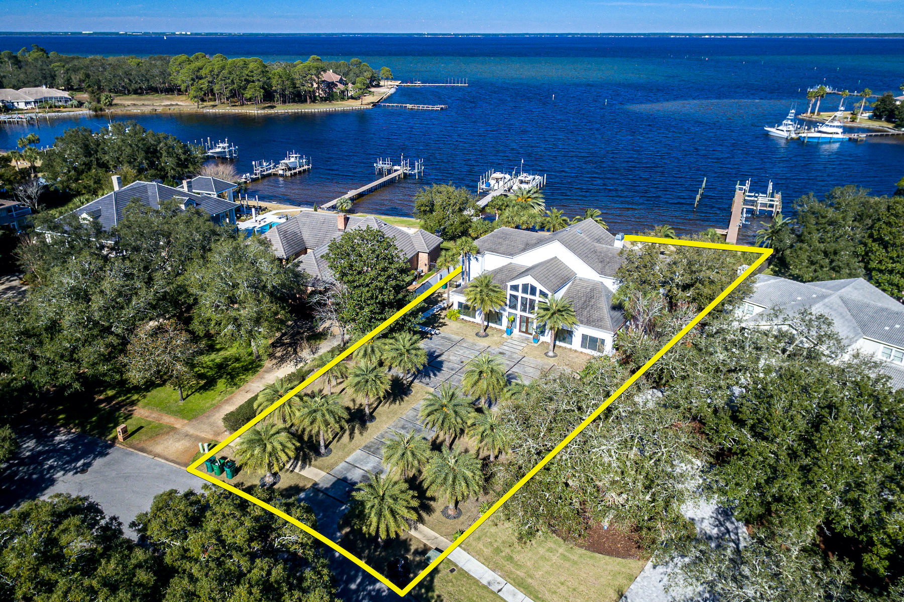Spectacular contemporary home with 138' feet on deep-water Indian Bayou directly across from Choctawhatchee Bay! This gorgeous residence features a 2+ story wall of windows for stunning water views and abundant natural light throughout. The huge living/dining/bar area is fabulous for entertaining, especially as it leads directly out to the large patio, pool, yard, and boat dock. 
   
Impeccably designed, the finishes are beautiful, functional, and decorative. Of special note is the incredible cabinetry throughout the home, which beautifully keeps to the home's contemporary theme, ensuring a clean, minimalistic feel while providing an amazing amount of storage capacity! The floorplan is perfect for modern lifestyles. Just off the dining area is the fantastic European-style kitchen... ...with an adjoining family gathering area and practical computer desk. The kitchen is oriented facing the water, with plenty of natural light. It features a large island, three sinks, soft-close drawers, both Silestone and granite counters, a large breakfast bar, and stainless appliances including two Gaggenau convection ovens, two dishwashers (Miele/Fischer Paykel), a Subzero fridge and freezer, Wolf stove, and much more. The bar area includes two wine refrigerators, plus cooling drawers, an icemaker, and a cappuccino maker.

The spacious master suite, located on the first level facing the water, features a gas fireplace, electric privacy blinds, steam shower, two sinks and separate vanity with Silestone counters, air tub, separate water closet, and an incredible walk-in closet that feels like an exclusive boutique. An additional bedroom suite on the first floor could easily be used as a home office and guest bath.

The stunning sweeping modern staircase leads to the balcony and two upstairs bedroom suites, each with their own baths, walk-in closets including washer/dryer, and balconies. The large sizes could easily accommodate guests or become a bonus/play room and/or large home office. A smaller media/playroom/sitting area is also on the 2nd floor. The current owners converted the garage into a first floor media/family room, but it could be converted back if desired. 
    
The incredible backyard offers a newly designed and finished large pool and raised hot tub feature, shaded sitting areas, large sun patio, large lawn, and a boat dock with two boat lifts, one offering 40,000-lb. capacity; a pontoon boat lift, jet ski lift, fish cleaning station, etc. Ideally located at the entrance to Choctawhatchee Bay, you can easily enjoy all the watersports of the Bay, as well as the Gulf of Mexico--or opt for golfing at Indian Bayou Golf Course.  
   
This special residence will make a wonderful home base for years of enjoyment!