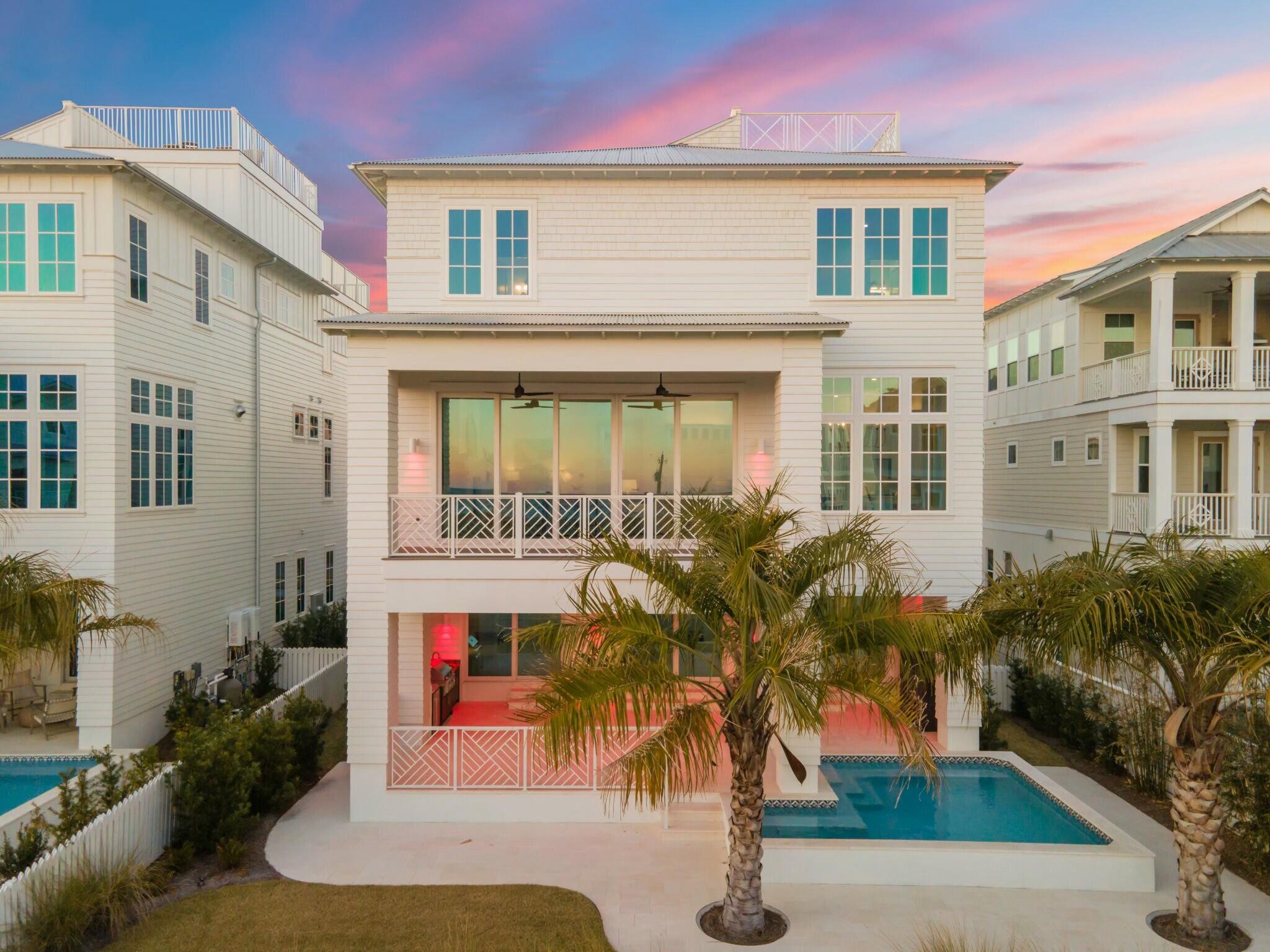 Just steps from the sugar-white sands of Inlet Beach, 35 Pompano Street is a masterfully built coastal retreat where luxury meets lifestyle. Newly constructed by CM Taylor Constructing with interiors by Bon Temps Interiors, this four-level estate blends refined design with effortless beachside living. Designed to sleep 20 comfortably, the home offers exceptional space designed to accommodate large groups or investment potential as a premier rental property.

The ground floor opens with a spacious game room, four custom built-in bunks, two full baths, laundry, and direct access to a private outdoor oasis—complete with a heated pool, summer kitchen, fireplace, and lush landscaping, all just steps from the dune walkover.

A private elevator connects all levels.  The second floor showcases open-concept living with Gulf views, a chef's kitchen featuring Wolf appliances, emerald tile backsplash, farmhouse sink, and a butler's pantry with ice maker. A Venetian plaster fireplace, designer lighting, and curated textures elevate the ambiance throughout.

Two primary suites each with spa-worthy en suites offer tranquil retreats, while additional guest suites with private baths provide space and privacy for all. The top level unveils dual rooftop terraces with panoramic Gulf views perfect for sunset entertaining. With parking for 7 (including a 2-car garage + golf cart space), and beach access mere steps away, 35 Pompano presents a rare opportunity to own a turn-key, income-producing luxury home along 30A.