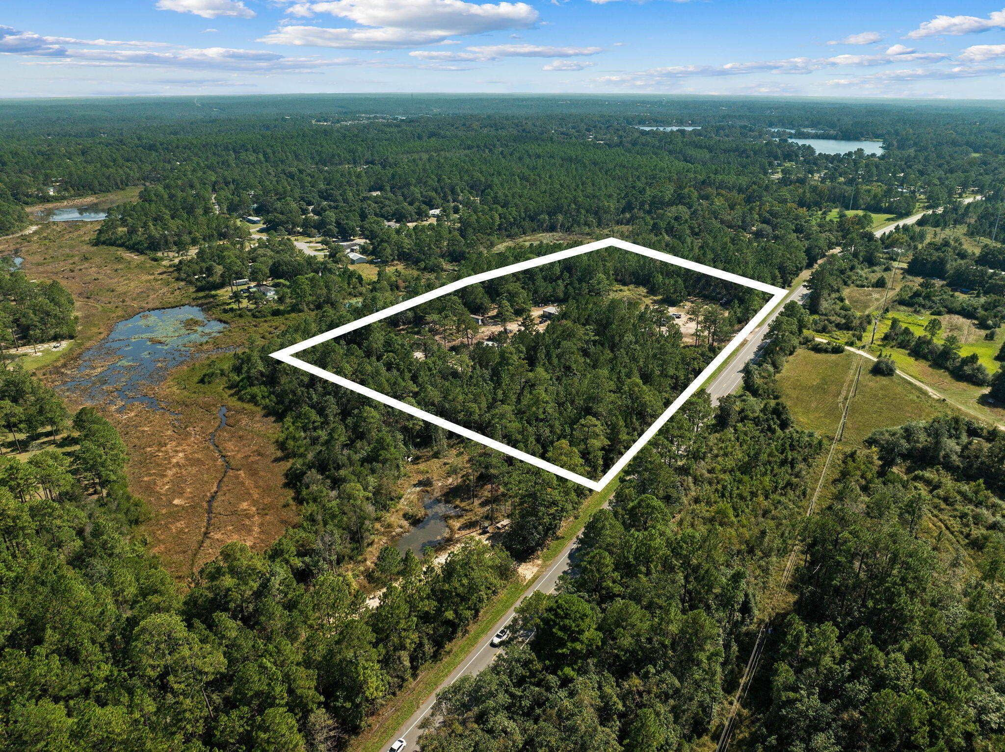 Hwy frontage along US Hwy 331! 4 Lots make up this 9.63 acre property, the front of the lots are situated along Hwy 331N, while the rear of the properties back up to Lake Rosemary. Current zoning will allow for up to 4 units per acre. With the possibility to convert the property to commercial allowing 12 units per acre. Converting from residential to commercial would require Walton County's approval. This land has so much opportunity; developing for housing, creating an RV Park or so much more. The property currently offers a 2 bay pole barn with a storage room, and a 3 bay pole barn. The property has electricity, a well & septic are both available, but the condition of them are unknown. This land has been used for 25+ years for heavy equipment including but not limited to (cont) to directional boring rigs, dump trucks, semi trucks, tractors, trailers, motor homes, etc. Phone lines have been on the property previously, condition is also unknown by the Seller.