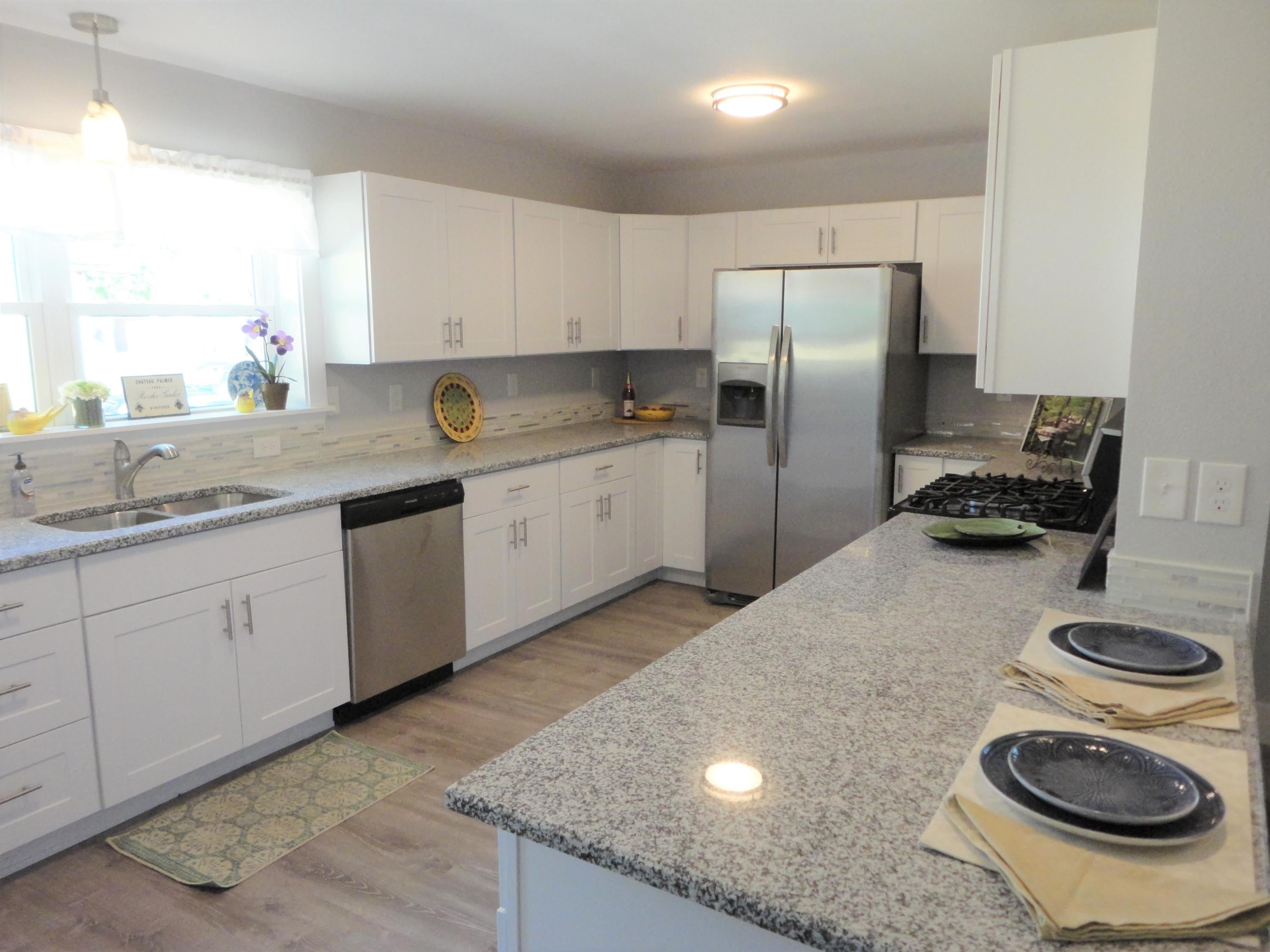 Look no more...this beautifully renovated home has it all. This home has been fully renovated and offers many bells and whistles. Starting with the gorgeous kitchen, you will enjoy the new white shaker cabinets and gorgeous new granite countertops. There are all new Frigidaire stainless appliances including a gas stove for the cook! The breakfast bar with the glass pendant overlooks the living and dining area.
The living room has a custom shiplap wall handmade by our talented carpenter. It's a beautiful focal point and sets off the new luxury vinyl grey floors and freshly painted walls perfectly. The living room has a sliding door to the new screened in porch. Perfect for Florida living.
The flooring throughout the house is a new luxury vinyl waterproof flooring. .  It is easy to clean and maintain.  No carpet anywhere!
The main bathroom has just been remodeled with a new tile shower and a custom cabinet to store your things.  You will also appreciate the custom barn door added, to eliminate a swinging door.  There are also new vanities, gorgeous custom tile, new lighting and fixtures in both bathrooms.  The tile detail in both bathrooms is beautiful.
On a practical note, the home was just rewired with all new copper wiring.  The lighting and fans have been updated throughout the house.  The entire home was painted both inside and out.  A new front deck was added along with new white shutters.  Out back is one of the main selling features.  You'll appreciate the oversized double garage.  This home is perfect for someone who wants to garage their cars or has a hobby or business they want to do.  There is plenty of parking for your boat or RV too.  The garage also has storage in the upper level which is a big bonus!  You will also appreciate the fenced back yard for your privacy and pets.
This home is close to schools and shopping yet tucked back from the main roads.  This beautiful home is ready for a new family!