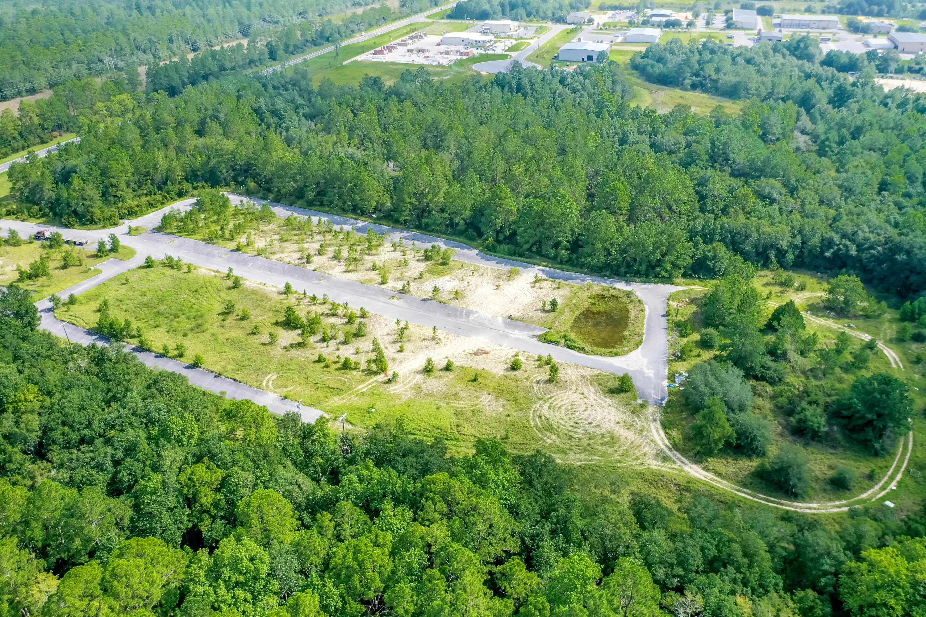 Fully Entitled Warehouse & Flex Space Project located in the heart of the emerging market of Freeport, Florida!  The infrastructure of the first phase of this two-phase project is in place and ready to accommodate vertical construction of warehouse and office space, which will cater to the enormous, national record-breaking growth of Walton County and surrounding areas!  Phase I is permitted for 43,170 SF of warehouse space and 20,918 SF of office space.
Phase II, once developed, will contain 74,182 SF of warehouse space and 35,514 SF of office space.
The total site area contains 12.68 acres, under a Light Industrial zoning district, and a future land use category of Industrial. This project is located nearly equidistantly between I-10 in Defuniak Springs and Highway 98 in Santa Rosa Beach; approximately 10 miles to the North and South, respectively.  
Whereas a similar project from a state of raw-land would take approximately 24 to 36+ months to achieve entitlements and develop like-kind infrastructure and site improvements, take full advantage of the current demand factor and lack of supply and commence vertical construction NOW!  Please inquire to coordinate a private site visit, and to view approved architectural plans. The approved site plan is uploaded to the Documents section of this listing.