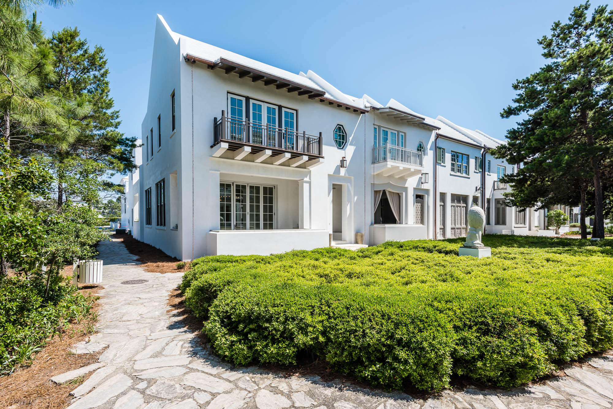 This spacious 3436 square foot custom Alys Beach residence is a part of the architectural vision that has its roots in the style of Bermuda architecture and the courtyards of Antigua, Guatemala. This home was built to evolve, maintain timeless traditions of sustainability all to the highest standards of design and construction. With 4 bedrooms, 4 full bathrooms and 1 half-bath, this residence is just feet from the infamous Caliza Pool and Restaurant and a simple walk to The Gulf Green beach access. This desirable end-cap site, directly overlooks Arboleda Park, and is steps from from the emerging Town Center, serene Lake Marilyn, and Clermont Tennis courts. The first level features an open living room that boasts ample windows and light and is perfect for family gatherings, fine dining, and relaxing.  With custom Dominican shell stone features, montage European Oak hardwood flooring, a high design, 12 ft high ceiling, summer kitchen complete with modern hardware and the finest of stainless steel appliances,  and a 2-car garage,  this floor is completed with a charming park-front view and comfortable exterior lounging area. 

The second level of this white masonry home welcomes you to 2,320 sq feet of four elaborate bedrooms with en suite bathrooms, that includes a master suite, master bath that combines Merola conchella in white seashell, with a drop-in tub poised inside of the showering area. The master suite, occupies the north wing of the residence to add to a uniquely private area , with a dedicated corridor and sitting alcove. There are three additional guest rooms that envelope a comfortable family room/ living area. The Guest master bedroom, and bathroom all encompass views of Arboleda Park. There is a lounging area directly adjacent to the master bedroom that overlooks the courtyard and pool area pulling in exceptional light for indoor relaxation.