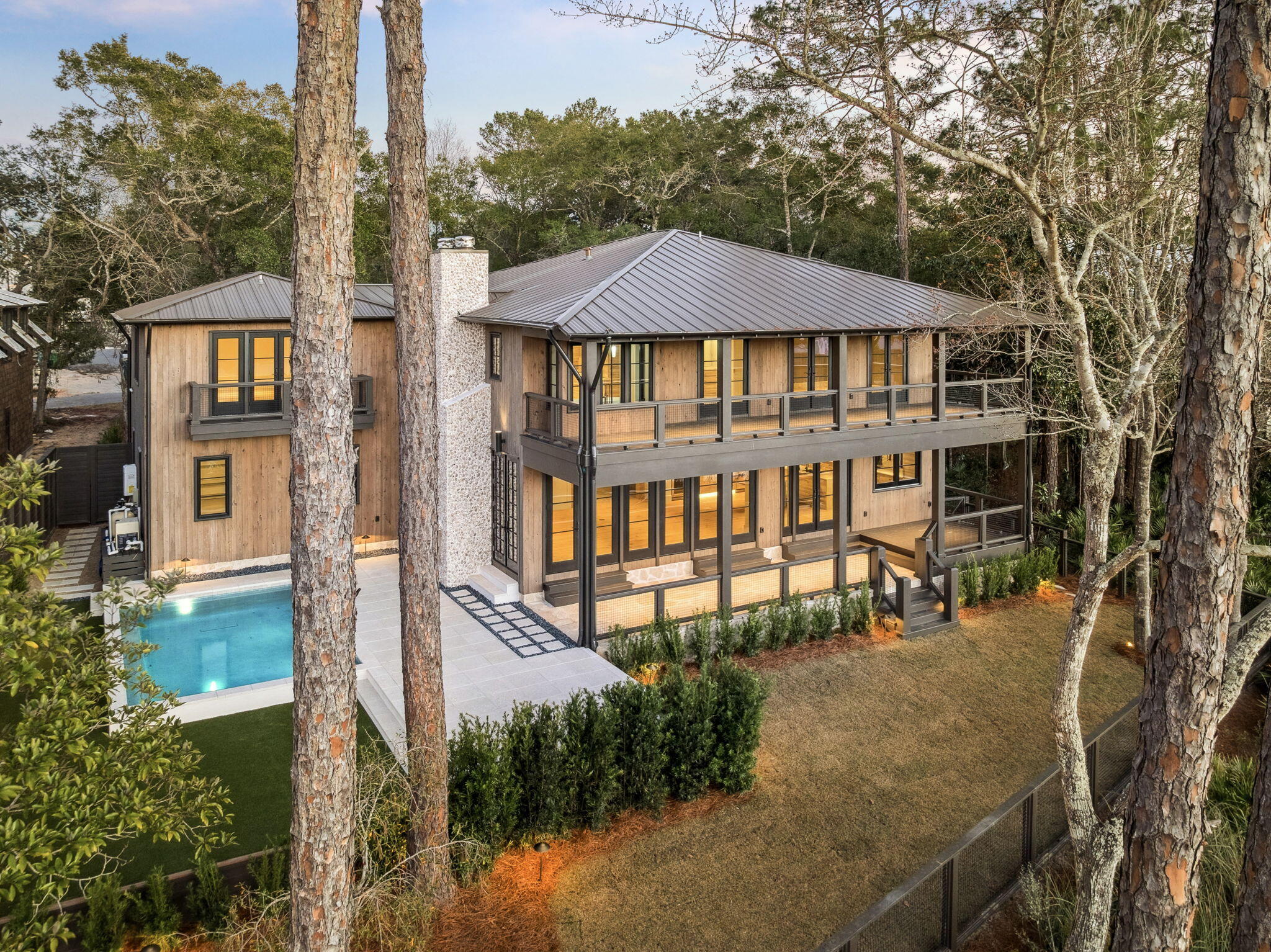 Welcome to Point Washington, a premier location near Scenic Hwy 30A and Eden Gardens State Park that offers the ultimate in waterfront living. This custom designed 4,720 sq. ft. residence features 5 bedrooms, 5 full baths, and 1 half bath. Situated among mature live oaks on Tucker Bayou, the property serves as a private retreat complete with a heated pool, outdoor fireplace, dock, boat house, and a custom sliding door opening to the waterfront porch & outdoor dining that overlooks Tucker Bayou which leads to the Choctawhatchee Bay. The interior showcases exceptional craftsmanship, including an entry hall wrapped in shiplap with immediate water views, a custom steel and glass entry door, ceiling beams, Italian limestone and Appalachian white oak floors. The main level is designed for entertaining with a seamless flow between the kitchen, dining, and living areas. Custom milled white oak cabinetry, Sub-Zero appliances, antique mirrors with shellstone countertops give dream kitchen vibes. The upper level includes a primary suite with water views from the expansive doors and windows that open to the full length private balcony, two walk-in closets, and a spa inspired bath with soaking tub, walk in shower and direct laundry room access. Additionally, a secondary living space provides a lounge area for your guest with wet bar, ice maker and beverage refrigerator. A carriage house accessible from within the home and from the garage below, features a West facing balcony overlooking the pool and Tucker Bayou. Located within a short distance to 30A and the beaches of South Walton, providing exclusive dining, shopping and entertainment. This home defines luxury and relaxation.