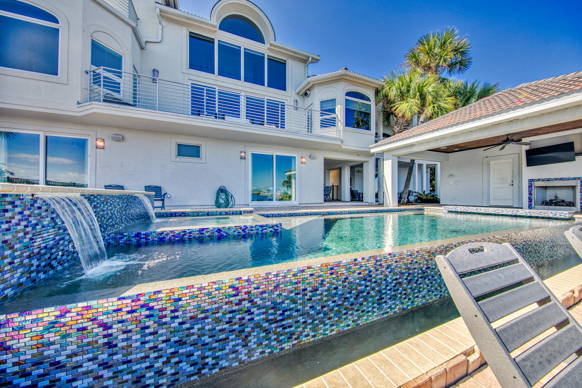 Destiny's Premier lake front residence. This contemporary style home features high end finishes throughout it's over 7,000 square feet of living space. Known as the White Pearl this home is an investors dream with over $ 417,000 of projected rental income. The property features a main house and guest house for a combined total of 11 Bedrooms, 10 Full Baths and 2 half baths. Home is permitted to sleep 34 and has parking for 12 cars. The premium finishes are not only inside the home but continue outside with an infinity lake front pool with waterfall and swim up bar. The pool area also offers an outdoor kitchen, gas fireplace and full bath. The main house offers a chef's kitchen with stainless Kitchen Aide appliances, custom cabinets, professional range, large island and wet bar. The living  area has a floor to ceiling windows that provide fabulous views of the water. The entire third floor is the master suite with custom bath. The guest house offers an additional 5 bedrooms 5 1/2 baths. Both homes have excellent views of the lake and Gulf.
