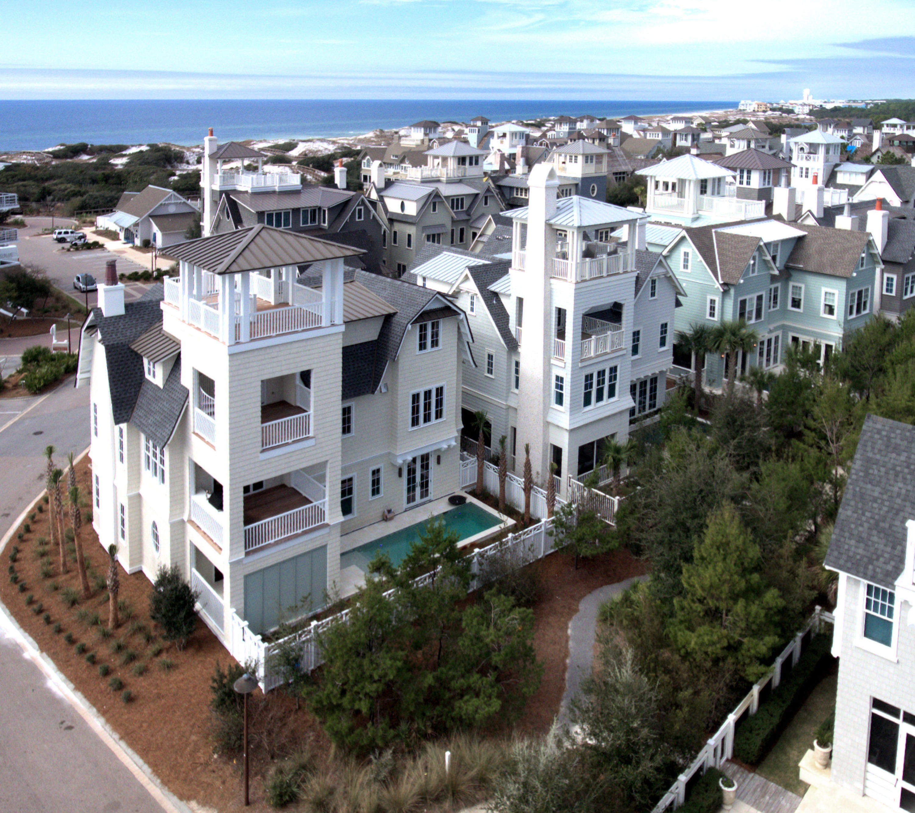 A Collaboration between the well-known Dune Construction and TS Adams Architecture is nearing completion and ready for you to make your own. The reverse open floor plan with large living-kitchen area uses its corner lot to capture views and breezes from the viewing corridor. The boardwalk leading through the dunes to the mile of beach frontage is 120 yards due south. The downstairs rec room leads to the spacious outdoor area with its inviting pool, screened sitting area, and outdoor fireplace. The third floor holds the master suite with a separate sitting area, wet bar, powder room, deck and covered porch which allows the owners to have guests to share the views or enjoy as their private retreat. Then the tower deck has forever panoramic views! 4,466 sqft with surprises everywhere. The second floor provides a large welcoming open kitchen, living and dining area. Off the dining room is a large screened grilling and dining area. The living area facing the beach has a large deck with a stacking door system. Also on the Second floor is a large office, pantry, powder room and 2 en suite bedrooms with a wet bar for their use. 
Downstairs is the indoor and outdoor recreation area. Places to play and soak in sun and fun.  There are an additional two en suite guests rooms located here. There is room for the whole family and all their friends. The attention to detain and beautiful finishes Dune Construction is known are everywhere.