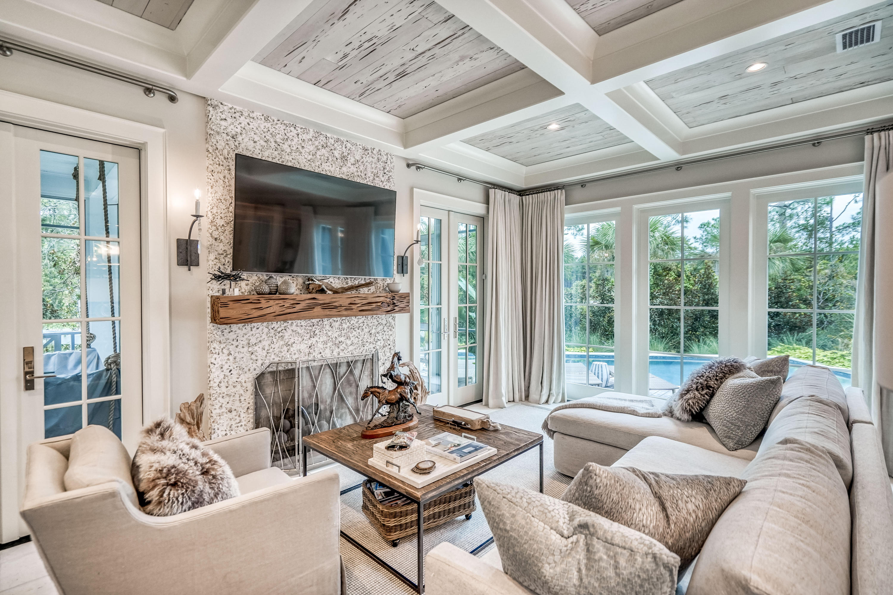Designed by Geoff Chick & Associates and built by Dune Construction, every detail of this 4BR/4.5BA WaterSound Beach home has been carefully curated to create a truly one-of-a-kind masterpiece. Notice custom details from the moment you enter such as stunning chandeliers from Lowcountry Originals, Rice White Peacock Paver floors perfect for going straight from the beach to the private pool, Pecky Cypress and coffered ceilings, and stunning tile work. The first level includes a spacious living and dining area with ample room for entertaining including a cozy screened porch with a bed swing and a second larger screen porch overlooking the pool with a built-in grill. Boasting one of  the largest private pools within the community, discover a lushly landscaped outdoor retreat with a 38' x 12' pool with a spa and ample decking for lounging. The gourmet kitchen features a large center island, floor-to-ceiling cabinetry, Cambria natural quartz countertops, and Sub-Zero and Wolf appliances including a 96-bottle wine refrigerator and a warming oven. The exquisite first level master suite has vaulted ceilings, shiplap walls and direct access to the poolside porch. Barn doors open to a stunning master bathroom with floor-to-ceiling tile, double vanities, a separate soaker tub and a walk-in show with custom tile inlay. An elevator services all floors or take the stairs to the second level where you'll find a library/study with built-in bookshelves, two guest bedrooms with ensuite bathrooms, and a third guest room with four built-in bunks and a private bathroom. On the third level, find a lounge room with a spiral staircase that leads to an open-air tower with gorgeous community, Gulf and lake views. There are two one-car garages that make it easy to store a golf cart and all your beach toys. This property is located in the Bridges neighborhood with a dock on Camp Creek Lake, walkway to the beach and a community pool.
 
Both sophisticated and stylish, the gated WaterSound Beach community located south of Scenic Highway 30A offers homeowners a rare sense of seclusion with easy access to area activities. Amenities include swimming pools, a puttering park, community green spaces, a state-of-the-art fitness center and private boardwalks to one of the most beautiful mile stretches of coastline in the area.