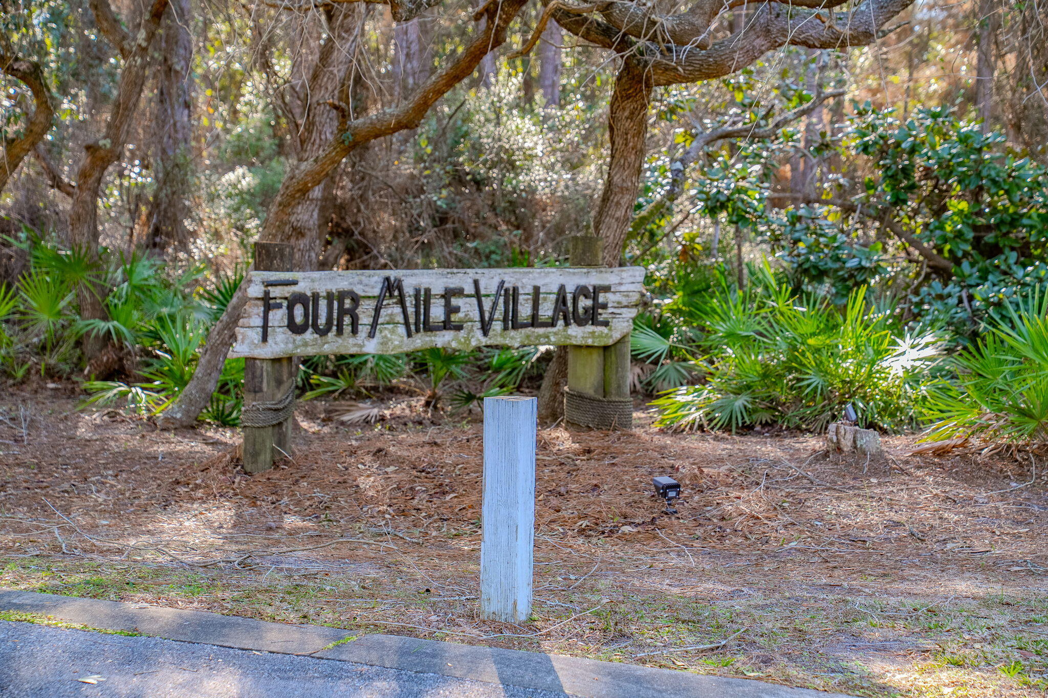 PRICE REDUCED !!Upon entering the gates of Four Mile Village you are experiencing the return to a more peaceful and tranquil  beach community!  It's like going back in time as the vegetation and mature oaks are untouched by developers. The deer run wild as Four Mile Village is a Wildlife Sanctuary. 211 Missile Hill Rd has never been offered for sale. Original owner. The setting is magical! Main house has 3 BR, 2 BA, and the attached apartment has an additional,  kitchen , BR ,living area and bath.  Finishes are original, and both the home and apartment need a major remodel.  With remodeling an enhanced view of Lake Fuller could be enjoyed and a possible gulf view.. 1.03 acre lot, with complete privacy. 2200 ft of private beach with private access.