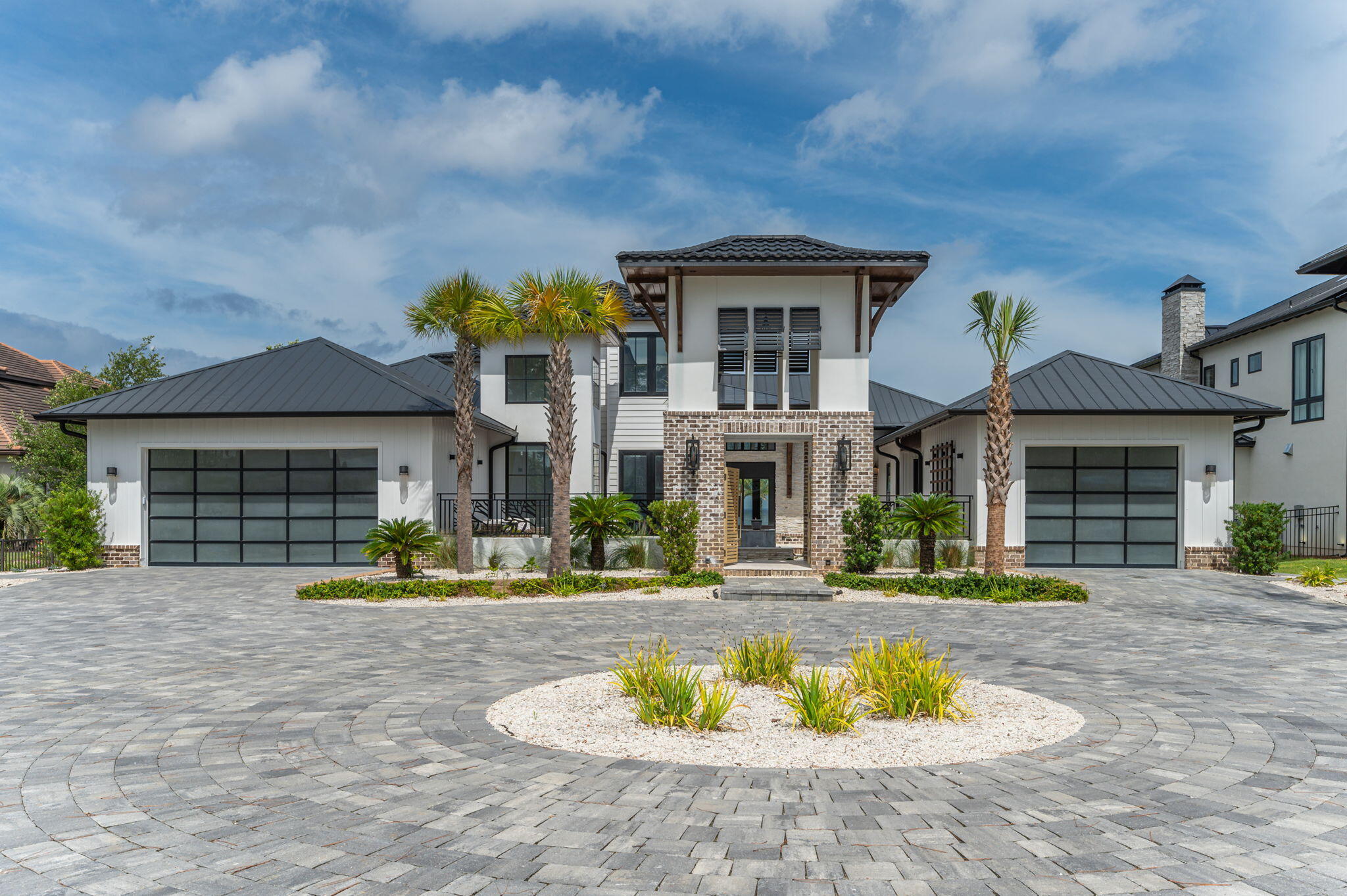 Pristinely poised on the coveted west-facing shores of Driftwood Point, this stunning bay front estate epitomizes luxury living. Spanning 6,347 square feet, this home blends modern amenities with expansive grandeur, offering incredible open living areas and the outdoor space of your dreams!

Upon arrival, you're greeted by an elegant, elongated entryway and a private parking court, perfect for hosting guests. Pass through the chic courtyard and step through the oversized pivot door and you're immediately met with breathtaking views of the Choctawhatchee Bay from the spacious living room. The open floor plan includes a cozy fireplace and floor-to-ceiling glass doors that open to the sprawling outdoor area, creating a seamless flow between indoor and outdoor spaces. An adjacent chef's kitchen with Dacor appliances throughout, including double ovens and dishwashers and a 48" gas range, a grand dining room, and a built-in bar are all designed to make entertaining a breeze. A temperature-controlled wine-room is perfect for preserving and showcasing your finest vintages.

The primary suite is conveniently located on the main level and features floor-to-ceiling glass windows showcasing the beautiful water views. The lavish en suite with a jacuzzi tub and expansive shower creates a private sanctuary for relaxation. The seller is in the process of thoughtfully adding a generous walk-in closet in the primary suite, creating a serene haven of organization and elegance. Two additional bedrooms with en suite baths, a spacious pantry and laundry area, a full bath off of the pool, and a stunning bonus space that can be outfitted to fit your needs round out the first floor.

Upstairs, you'll find an incredible theatre room, a thoughtful play area, one bedroom, a full bathroom, and a craft room or flex space. This level is perfect for family living or guest accommodations.

The outdoor space transforms the property into a private resort. The expansive lot features direct access and undisturbed views of the Choctawhatchee Bay, enhancing the property's appeal. Enjoy year-round sunset vistas that will take your breath away while relaxing in your secluded retreat. The inviting pool, complete with a hot tub and sun shelf, is perfect for leisurely days spent enjoying our beautiful Florida weather. The cabana, offering a professional-quality gym with sweeping views of the Bay, also features a sitting area, bathroom, and steam shower. It could easily be converted into a guest house if you desire. The full outdoor kitchen includes an Evo flat top grill, Advantium oven, beverage refrigerator, and warming drawer. With dining space, an outdoor tv, and a sitting area with a large fire feature, it makes the perfect setting for al fresco dining and evening gatherings. The backyard oasis includes a putting green and extends to a private dock equipped with a jet ski lift and electrical provisions for a boat lift, making it a dream for waterfront enthusiasts. Imagine boating from your own backyard to dinner at Baytowne Wharf or the Destin Harbor, or heading straight to Crab Island or the East Pass for a full day of fun in the sun.

Crafted with meticulous attention to detail, the home boasts spray foam insulation, hurricane-rated windows, and doors with aluminum cladding, ensuring both security and energy efficiency. The impressive 8-foot pivot front door adds to the home's grandeur.

With an attached two-car garage and a detached one-car garage with covered access, there is no shortage of space! The fully insulated and air-conditioned garages accommodate three vehicles plus additional storage or a golf cart. The pristine epoxy floor adds a touch of sophistication.

This exceptional home is a rare opportunity to experience unparalleled luxury in a serene setting. It's perfect for outdoor water enthusiasts and takes full advantage of the emerald coast lifestyle. Conveniently located near the premier shopping, dining, and entertainment at the shops of Grand Boulevard and the famed Sandestin Resort, this property is also close to Sacred Heart Hospital and the pristine white sand beaches and emerald green waters of Scenic Highway 30A in south Walton County.