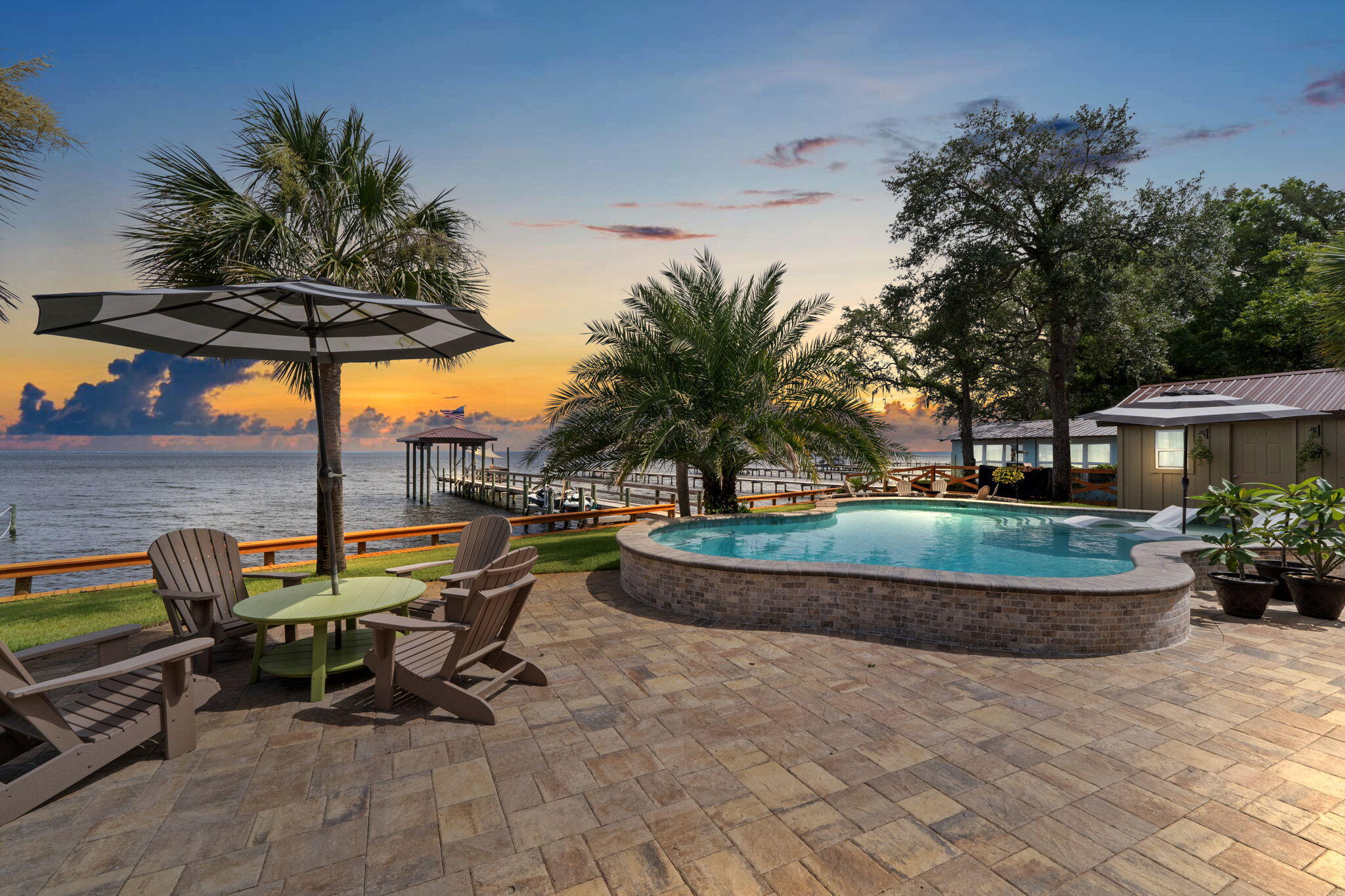 Step into the comfort of this well-positioned home in Gulf Breeze, located at 5938 E. Bay Blvd. This inviting 4 bedroom, 3 bonus room, 5-bathroom home boasts a generous layout including a large great room at the front and a cozy den with a fireplace at the back, perfect for relaxing while enjoying views of the Bay. 

The custom design was well thought out with details and precision during construction. The home is less than 4 years old and has over a half acre that is positioned to admire sunset views. 

There is 2 master ensuite rooms of your choice. One is on the first level off of the kitchen area and the other is upstairs for more privacy. The spa like bathrooms will have you feeling like you are on vacation for a lifetime.

Half bath for the pool and outdoor guests and another half bath for the flex/ gym room inside. The layout of the rooms gives everyone privacy, space, and the goals you have always desired for those extra rooms. There is another "bonus office" room right off of the foyer. If you still need more space, you will really enjoy the upstairs craft/ art/ game room away from the rest of the family. 

The outdoor area will be one of the favorites to enjoy the pool, dock, outdoor kitchen and lounge area. Additional storage shed is outside right near the half bathroom. 

The waterfront is surrounded by rip rap with a seawall, including a bench area around it. This home is a MUST SEE if you are looking for a home on the Bay. 

Please see our video, feature sheet, and other important documents to inquire about. We have all the info you need! 
WALK THRU VIDEO AND 2D FLOOR PLAN IS COMING SOON!