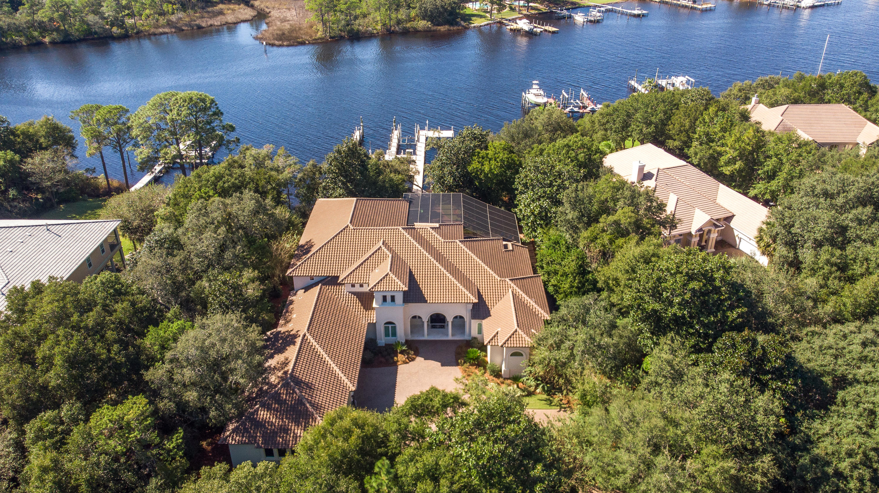 Perfectly positioned on a quiet cul-de sac in desirable gated Kelly Plantation, on one of the finest deep water lots in Destin!  Absolutely stunning one owner, custom home offers an unobstructed and protected view across the bayou, a high elevation and superior dockage....this is a boater's paradise!  Extremely private setting!  Fabulous Sater design features impressive double entry doors opening to a large gallery style foyer, a large living room and dining room.  To the left is a convenient wet bar, adjoining gourmet kitchen/casual dining/family room.  Soaring ceilings, large windows and sliding glass pocket doors allow for lots of natural light and direct access to the lanai.  Any cook will love this kitchen, with abundant cabinetry, granite counters, center island, upgraded appliances including a Wolf 6-burner gas range with double oven, Subzero refrigerator, Bosch dishwasher....an the scullery is amazing!  It's
more than a pantry, with tons of storage and built-ins, you'll wonder how you ever lived without one!  For the wine enthusiast, there's a climate controlled 800 bottle wine cellar.  A handsome office adjoins the living room and the master wing.  The mater features a spacious bedroom, two incredible custom walk-in closets, his and hers private water closets and the bath of your dreams...with dual vanities, heated floors, jetted tub and a tremendous walk through shower.  Two ensuite guest rooms are also on the first level, as is the laundry center. On the second level, accessible also by an elevator, is an open loft area, currently used as a billiards/game room.  The "brain room" housing the electronic equipment has its own space, which open into a large heated and cooled storage area that could be used as a playroom, hobby room, exercise or craft room.  A sound proof music room, with it's won HVAC adjoins this area and could also be a theatre room.  Seller's have also installed a $20,000 surround sound system.  Back on the first level and accessible from the family room, office and master is an outdoor oasis....a large screened lanai with sparkling pool, spa and kiddie pool, plenty of covered spaces, a spacious outdoor living area with fireplace and full summer kitchen.  Just a few steps from the lanai is a fire pit and just beyond is superior dockage, with two slips accommodating large vessels, one lift and two personal watercraft lifts. It's just a short ride to the bay, Crab Island, Destin Harbor and the Gulf!  This is what living on the water is all about!  One of the few homes in Kelly Plantation to offer a full 4-car garage and it is tricked out! Additional custom features include raised ceilings, recessed lighting central vac, security and surveillance system and more.  For added peace of mind, this home is equipped with a whole house generator, which also powers the dock, in case of power outage. Superior construction, quality materials and an eye for detail make this beauty a must see!  As always, all dimensions important to the buyer should be verified.