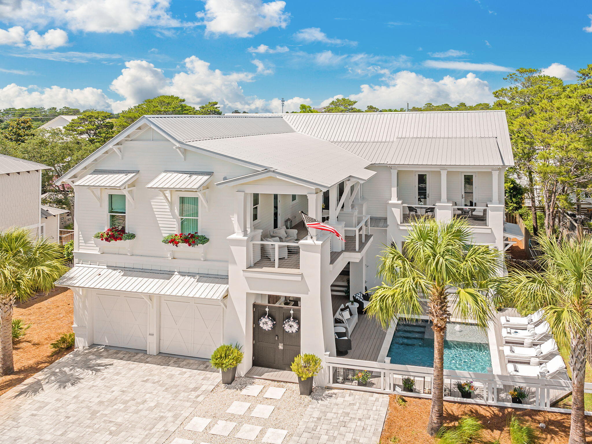 Where refined coastal architecture meets the most coveted stretch of 30A.
Nestled in the heart of Gulf View Heights along Scenic Highway 30A, this exceptional coastal estate redefines luxury beachside living. Just a five-minute stroll to the sugar-white sands of Gulf View Heights Beach Access, this six-bedroom, six-bathroom residence spans over 4,060 square feet of impeccably designed living space, seamlessly blending timeless architecture with modern indulgence. Upon entry, the grand living room captivates with 22-foot coffered ceilings, creating a dramatic sense of volume and sophistication. The chef's kitchen serves as the heart of the home, featuring a massive quartz island, commercial-grade KitchenAid appliances, a six-burner gas range, built-in refrigerator, ice maker, and a striking statement range hoodperfectly suited for both elevated entertaining and everyday luxury. Coffered ceilings continue throughout, while the formal dining room is enhanced by a custom wet bar with wine chiller, ideal for evening gatherings.

Expansive French patio sliders open to a private courtyard oasis, where indoor and outdoor living blend effortlessly. The fully equipped summer kitchen boasts a built-in Coyote grill, refrigerator, warming drawer, and quartz countertops, all set atop elegant travertine tile. The courtyard flows seamlessly to the resort-style pool deck, complete with composite decking, travertine coping, and ample lounging space for soaking up the Florida sun.

The main level also offers a versatile bedroom currently utilized as a home gym, a full bath, and a stylish half-bath for guests. Upstairs, a spacious loft anchors the second level, accompanied by two guest bedroomsincluding one transformed into a custom-designed closetconnected by a Jack & Jill bath. A private home theater suite features its own spa-inspired bathroom with soaking tub, walk-in shower, and dual vanities.

The primary suite is a true sanctuary, offering a private balcony, expansive walk-in closet, and a luxurious en-suite bath with soaking tub, oversized shower, and refined finishes. A second wet bar off the loft enhances evening convenience, while the oversized laundry room provides abundant cabinetry, counter space, and a utility sink. One of the upper balconies overlooks the pool, extending the home's elevated outdoor living.

Additional highlights include a Generac whole-home generator, infrared outdoor heaters, custom wallpaper and draperies, and all-new designer lighting throughout. The grounds are further enriched by mature fruit trees, including orange, lime, lemon, and grapefruit.
Ideally positioned moments from world-class dining, boutique shopping, and the iconic beach towns that define 30A, this remarkable residence offers a rare blend of privacy, luxury, and walkable beach access. Scenic Highway 30Awhere crystal-clear waters, charming coastal communities, and timeless elegance converge.
Experience coastal living without compromise.
Welcome to your legacy home on 30A.