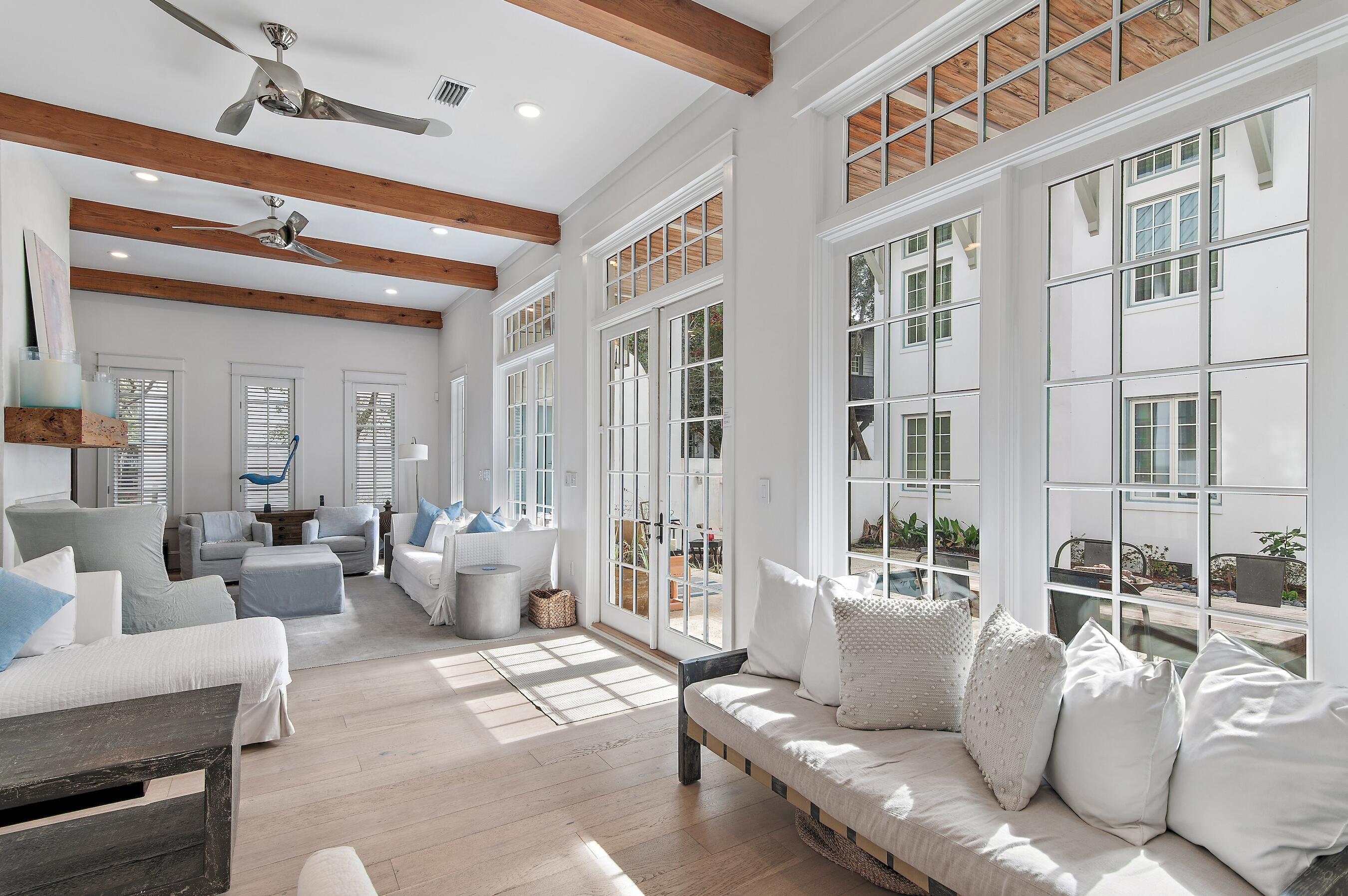 Welcome to 90 N Cartagena Lane, an exquisite residence nestled in the heart of Rosemary Beach, south of Hwy 30A, in a quiet cul de sac, offering privacy and seamless access to the community's coveted deeded beach access. This exceptional property showcases extensive renovations from 2013 to 2021, blending timeless charm with modern sophistication. Step inside to find light-filled interiors with elegant finishes, including rich hardwood floors, detailed millwork, and designer fixtures. The first floor open-concept living area flows seamlessly into the gourmet kitchen, featuring custom cabinetry, premium appliances, and a spacious island perfect for entertaining.The primary suite is a serene escape, complete with a spa-like ensuite bathroom and private balcony access. Three additional spacious bedrooms in the main house offer comfort and style, each thoughtfully designed with ample natural light and tasteful decor. The separate carriage house provides additional living space, featuring a bedroom and bathroom, ideal for guests or a private retreat.  Outdoors, enjoy the lush courtyard, perfect for alfresco dining, and relax on the expansive porches. A fenced backyard enhances privacy and security, while a saltwater heated pool adds a touch of luxury, creating an inviting space for relaxation and recreation. The 2-car garage offers convenience and storage. Located just a short distance from the Gulf, 90 N Cartagena Lane embodies the best of Rosemary Beach living. Arrange your private tour today to explore the beauty and elegance of this remarkable property.