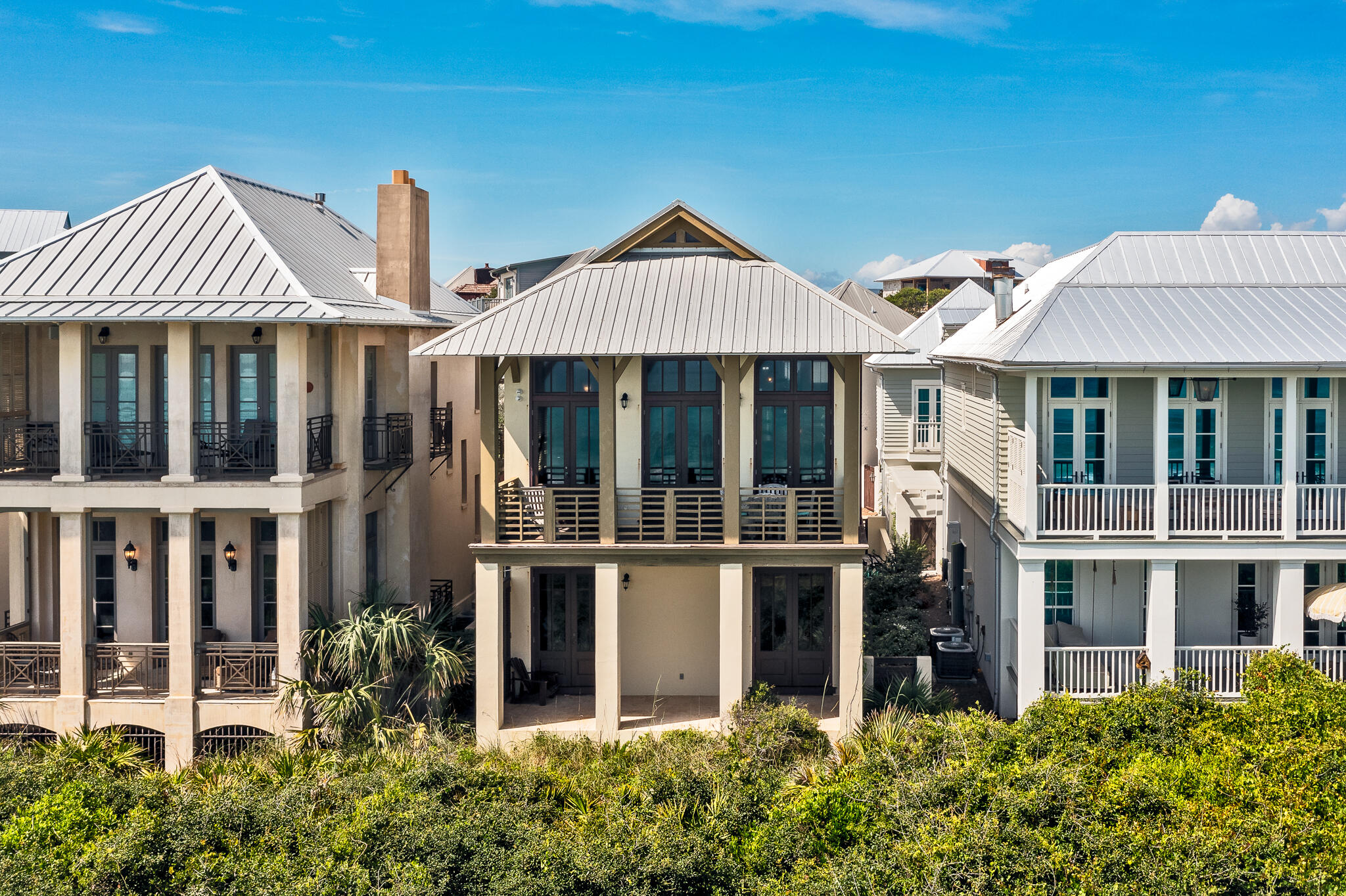 Welcome to 84 Windward Lane. Beautifully-designed, and thoughtfully-executed, this gorgeous home sits in the heart of Rosemary Beach and offers you a gentler, more luxurious way to live. 84 Windward Lane features 34 feet of premium Gulf frontage and BREATHTAKING panoramic views of the Gulf of Mexico. The main house features three bedrooms, three full bathrooms, and the carriage house features an additional bedroom and full bedroom WITH a full-sized kitchen, living area, AND two terraces. Enjoy the views of the Gulf and surrounding neighborhood from the several terraces the beautiful home features. 84 Windward Lane welcomes you onto the first floor with 10' ceilings, solid mahogany French doors, two king-sized bedrooms, both with full ensuite bathrooms, which opens onto a private, covered porch. Head upstairs to the second floor, which opens onto one big living area. Enjoy the exposed beams which anchor the soaring vaulted cathedral ceiling and wall-to-wall ceilings. Natural light floods the living area, keeping the room bright and sunny all day long. Grab a snack from the open kitchen with granite countertops and bar seating and head out onto the full-length balcony- truly the centerpiece of the home. 
A unique spiral staircase leads to the third lofted king-sized bedroom. This home is not only beautiful, but practical as well, as it features a gorgeous and LARGE carriage house as well. After exiting the main house, head over to the two-car garage and into the carriage house. Vaulted ceilings and large windows bring you the same charm as the main house, complete with full bathroom, kitchen and living area. Another spiral staircase leads you to a lofted king-sized bedroom and two separate terraces. The carriage house also features panoramic Gulf views! Rosemary Beach offers amenities such as tennis courts, fitness center, owners pool, four community pools, and more, all a quick walk or bike ride from 84 Windward Lane. Don't hesitate to schedule your viewing today!
