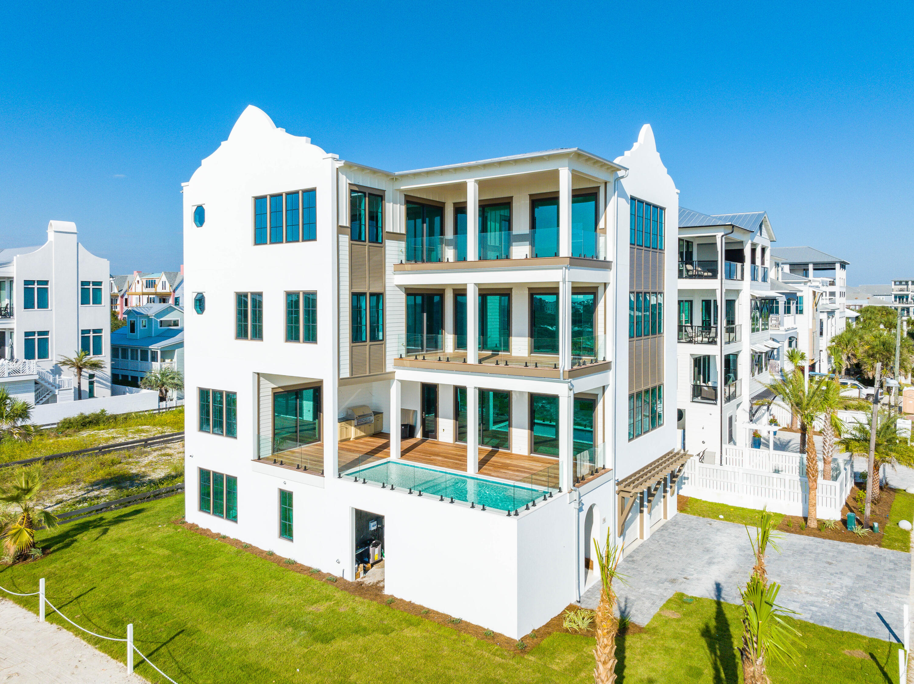 Under Construction- 91 Emerald Cove, blessed with forever Gulf-front views, is arguable one of the best lots on 30A. 91 Emerald Cove Lane is steps away from the emerald Gulf waters and sandy white beaches. This stunning new home was sure to capture that, with huge windows framing every inch of the gorgeous water views. The close walkover will take you directly to the water, and miles of the beautiful, sugar white sandy beach! This gorgeous home also boasts forever Gulf views. 
This brand-new build features over 6,875 square feet offers plenty of space for family and friends.

Buyer to verify all information and dimensions. Information is deemed reliable but not guaranteed. You'll also enjoy the gorgeous white interior with floor-to-ceiling windows and a seamless integration of the indoor/ outdoor living experience with covered balconies on every floor.

This cutting-edge, modern design extends to the kitchen with lovely white cabinetry, brand-new appliances, and beautiful chandelier in the living space. Enjoy the luxurious master suite, complete with French doors that lead to a large covered patio facing the Gulf. The en-suite bathroom is just as nice, with modern-meets-coastal design that's reflected in white marble, a large soaking tub and beautiful chandelier. Guest rooms are complete with beautiful water views as well! 

Experience the 30a life with a beautiful coastal home like 91 N Emerald Cove Lane. Perfect as a primary residence or second home, or even as a vacation rental, don't miss out on the opportunity to own a part of the beach with 91 N Emerald Cove Lane.