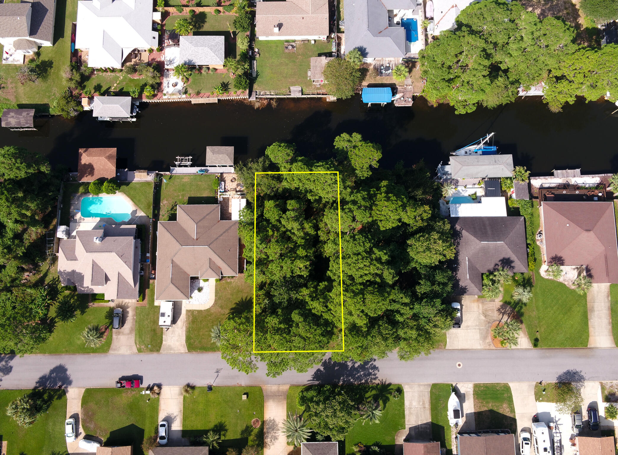 **Build Your Dream Waterfront Retreat!** Discover a rare opportunity to own a beautiful homesite in the highly sought-after waterfront community of Polynesian Islands in Gulf Breeze. With 70 feet of waterfront, you have the perfect canvas to design your ideal boat house or lift and enjoy effortless days on the water. This spacious lot offers ample room to create the custom home and pool you've always envisioned—bring your plans and your imagination. Privacy is a standout feature here: the adjacent lot to the right is owned by the neighboring home and is planned to remain natural, giving you added space and a serene setting with no immediate neighbor on that side. Living in Polynesian Islands means enjoying a community boat ramp, top-rated Gulf Breeze schools and unbeatable convenience to  Pensacola Beach, Navarre Beach, Pensacola International Airport, and vibrant downtown Pensacola. Survey available in documents. Secure your slice of coastal paradise and start building the lifestyle you deserve.