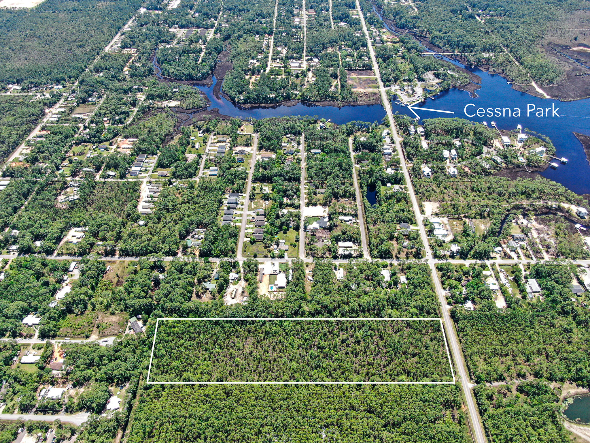 This 9.75 acre tract of wooded land has 330' of frontage on Hwy 393 North that is less than a mile to the Choctawhatchee Bay.  This property has uplands and some very minor wetlands to the rear.  Great opportunity for development and currently zoned Conservation Residential 1:2.5 allowing 1 dwelling per 2.5 acres, so it can be developed with a maximum of 3 dwellings units which will required a preapplication meeting and development order. Located in Flood Zone AE.  Buyer to verify lot dimensions, restrictions, utilities and all zoning requirements.