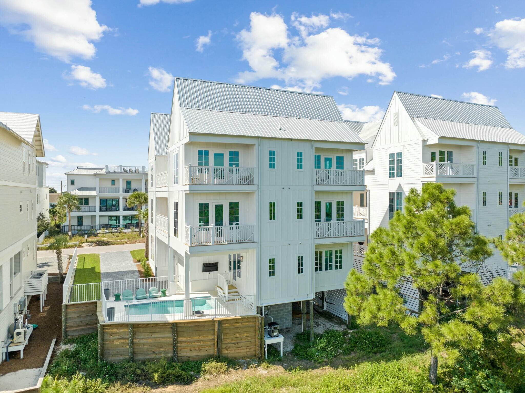 Woodward Drive is a modern beach oasis near the sought-after 30A, with breathtaking coastal vistas that will leave you amazed. The impressive 6-bedroom, 6-bathroom house has been meticulously designed with careful attention to detail throughout.

As you step inside, you'll be greeted by a vision of elegance and sophistication. The interior is adorned with custom white cabinetry and crisp white walls, creating a modern and timeless aesthetic that is both chic and refined. The open plan living room and dining room are bathed in natural light and offer incredible panoramic views that will take your breath away.