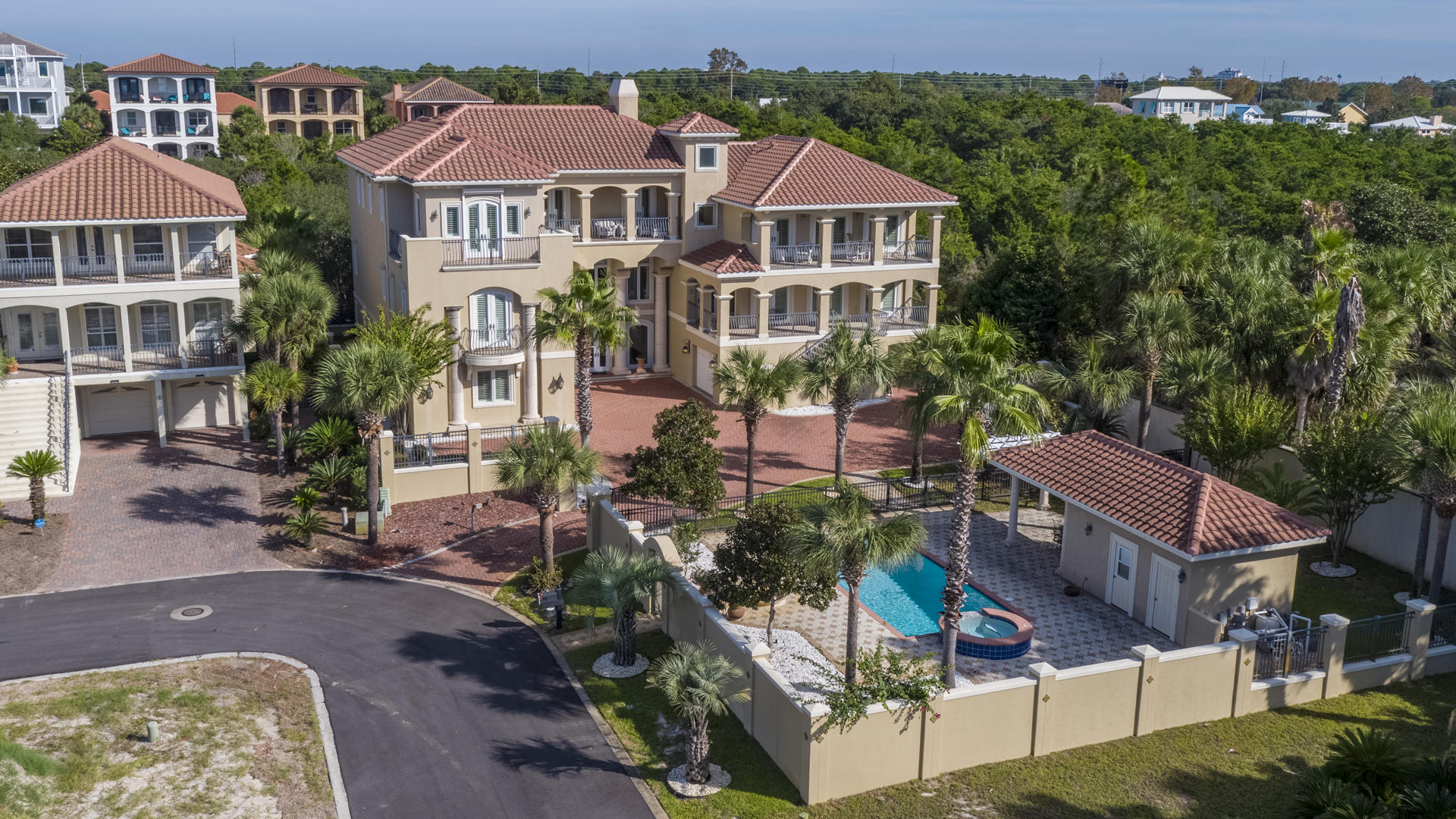 A grand masterpiece, this gorgeous custom Mediterranean style gated estate combines fine craftsmanship and skillful design. Sited on three highly-desirable lots, the 9,100 square foot residence is in an enviable position in a quiet coastal setting discreetly tucked off Highway 98 in Miramar Beach, Florida. Central to the very best of the Emerald Coast, both Destin's vibrant harbor and the relaxed sophistication of South Walton are only moments away. Even closer, dedicated beach access, which is readily available down a dead-end lane and with no major roads to cross. Gulf breezes scented with magnolia blossoms can be relished throughout the immaculately maintained grounds or from one of four large Gulf view balconies. Outdoor living is divine with a 24' x 13' heated pool, waterfalling hot tub, and a pool house cabana - outfitted with a Thermador gas grill, mini-fridge, wet bar, indoor storage area, and a full bathroom.

The sprawling brick paved motor court is accented with three separate garages and leads to a grand entrance with soaring double height columns. This three-story home is comprised of six bedrooms, 5 full baths, and 3 half baths and is uniquely designed for multi-generational living. Created with the intention to facilitate multiple families under one roof, this property hosts three separate living areas, two kitchens, three laundry rooms (one on each floor), and an over sized billiard room outfitted with a wet bar, ice maker, and wine fridge.  A portion of the home can be completely closed off to create attached separate living quarters for in-laws, a live-in nanny, or a wealth of other possibilities. 

On the second floor and accessible via a private residential elevator off one of the garages, two interior staircases, or an exterior staircase decorated with Talavera tiles on the risers is the principal living space. The den is centered on a gas fireplace and a built-in flat screen television, discretely concealed behind an elegantly framed retractable oil painting. Nearby an electronics closet houses components for the entire home audio (inside & out), security, Lutron light, and intercom systems. Adjoining this space, a gourmet kitchen contains maple custom cabinets, granite counter tops, dual islands, double ovens, double drawer dishwashers, Sub-Zero refrigerated drawers, top-of-the-line GE Monogram Refrigerator, pot filler over a gas cook top, walk-in pantry, bar, and a kitchen dining area. The formal dining room is anchored on a Schonbek crystal chandelier and features a Romeo & Juliet balcony with views overlooking the grounds of the compound and the electronic security gate with a camera, intercom, and remote. Also on this level, ancillary living, kitchen, and dining areas.

Crowning the castle, a massive master suite on the third floor boasts a soaring vaulted ceiling, fireplace, sitting room, breakfast bar, and built-in computer workstation. The over sized closet is replete with custom cabinetry and a safe. The master bathroom features a large walk-in shower with three heads and a body sprayer as well as a soaking bubble tub, dual vanities, and a lovely chandelier. Also off this suite is a private study with a balcony and captivating gulf views.

Additional amenities include hurricane shutters, high impact windstorm certified windows, French doors, wood plantation shutters, custom drapes, central vacuum system, 8' to 10' ceilings, crown molding, barrel terracotta roof tiles, well with Rain Bird sprinkler system, exterior gas lanterns, citrus trees, and decorative fountains.

Don't miss out on this incredibly rare opportunity to own a unique home of this caliber. This could be your ideal forever trophy home or a lucrative vacation rental investment property with projections topping $300K annually.
