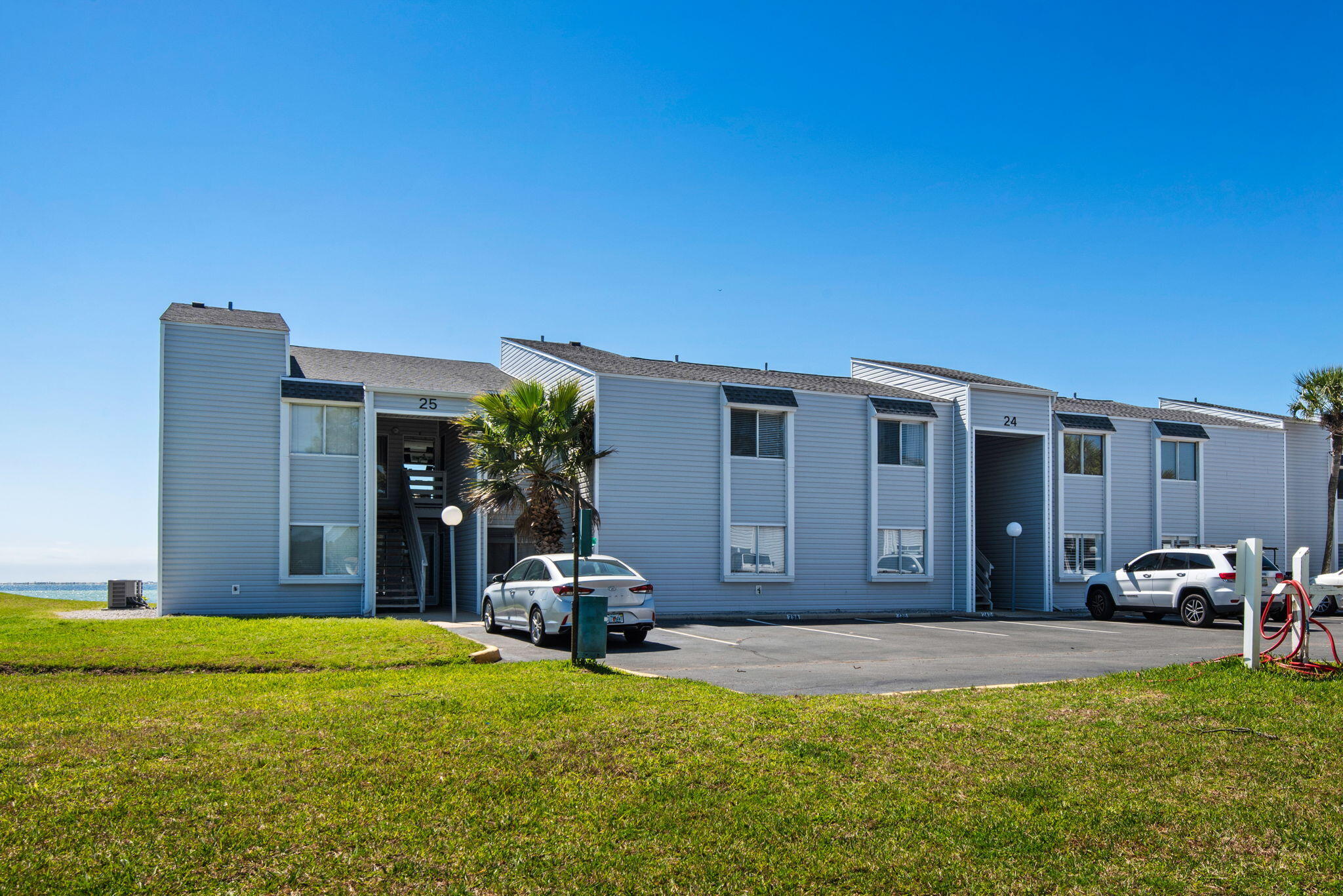 Unit 24A at Finisterra presents a rare opportunity to own a fully renovated, turn-key waterfront condo with panoramic views of Choctawhatchee Bay, the Destin bridge, and Okaloosa Island. Ideally positioned in a coveted direct waterfront location, this beautifully updated 2BR/2BA residence captures water views from nearly every window. Designed for low-maintenance, easy living, the condo was thoughtfully renovated in 2020 with high-quality, modern finishes throughout, including quartz countertops, updated cabinetry, new flooring, contemporary lighting and fixtures, stainless steel appliances, a stacked washer/dryer, and impact windows and doors. Major systems have already been addressed, including copper wiring, HVAC, and water heater (2022), while the building offers additional peace of mind with a new roof and vinyl siding completed in 2023. Set within a gated waterfront community along the shores of Shalimar, Finisterra delivers a lifestyle rarely found at this price point. Enjoy a sparkling pool, pickleball courts, and direct water access for launching your kayak or paddleboard and exploring the bay at your leisure. Spend your days fishing along the shoreline or strolling scenic waterfront paths just steps from your door. Whether you're seeking a full-time residence, second home, or coastal retreat, Unit 24A offers a move-in-ready experience with minimal upkeep, stunning views, and exceptional lifestyle value.