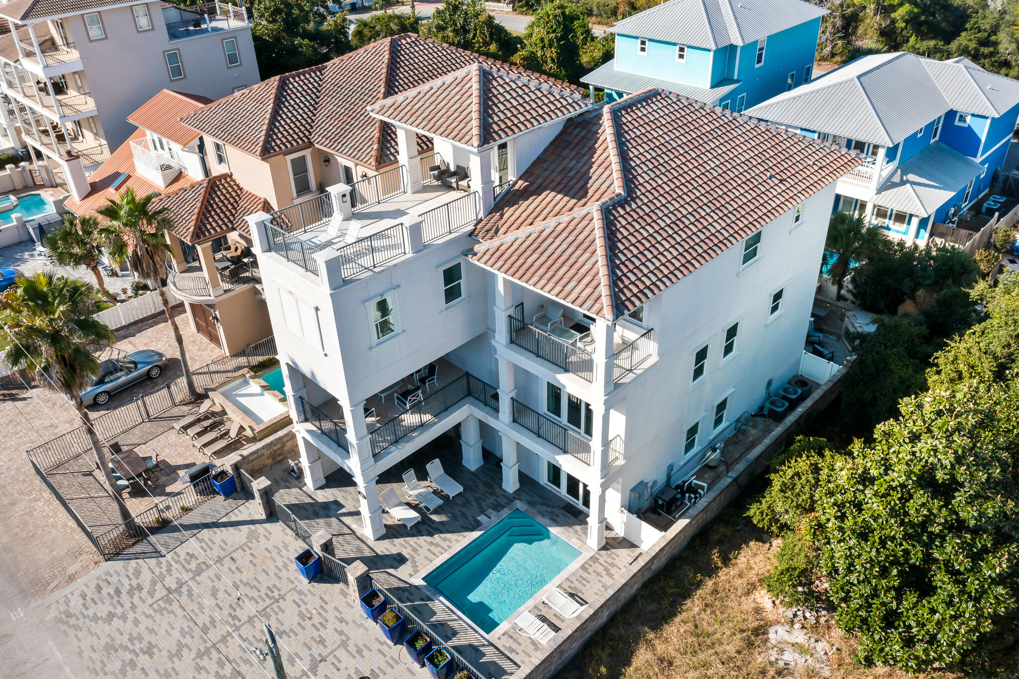 Welcome to 84 Sarasota, a beautiful coastal retreat offering Gulf views and luxurious amenities at every turn.  Bring the whole crew to this vacation oasis, which provides enough bedrooms to sleep 24, a game room, multiple living and flex spaces, and oversized kitchen and dining areas.  Rental projections of $225,000 annually.  Outside private amenities include a heated pool, over 1000' of deck space, a summer kitchen, a fireplace, covered lounge areas, and ample porch space to enjoy year-round! There is something for everyone to enjoy. The deeded beach access is an easy walk or golf cart ride. As you enter the home, you are greeted with a fun room! Shuffleboard, arcade games, pool table, card table, board games and puzzles... you won't be disappointed on a rainy day here! This floor also offers two large bedrooms with custom built-in bunk beds. As you approach the main living space on the second floor, you will be greeted with abundant natural light, multiple dining spaces, and an expansive living room that continues as you bring the inside out with a large covered outdoor living area. The kitchen offers two refrigerators and freezers, a large pantry, and ample cabinet space. There is a large guest suite on this floor that sleeps 4. The 3rd floor has four en-suite bedrooms and a 5th bedroom with a wet bar, which can be converted to a theatre/media room if desired. The 4th floor rooftop deck has beautiful views with plenty of room for your private sunset. This is your opportunity to own an investment that you can also enjoy. This property has been very well maintained. Rental income history and potential are available upon request. Call to schedule your private tour, whether virtual or in person.