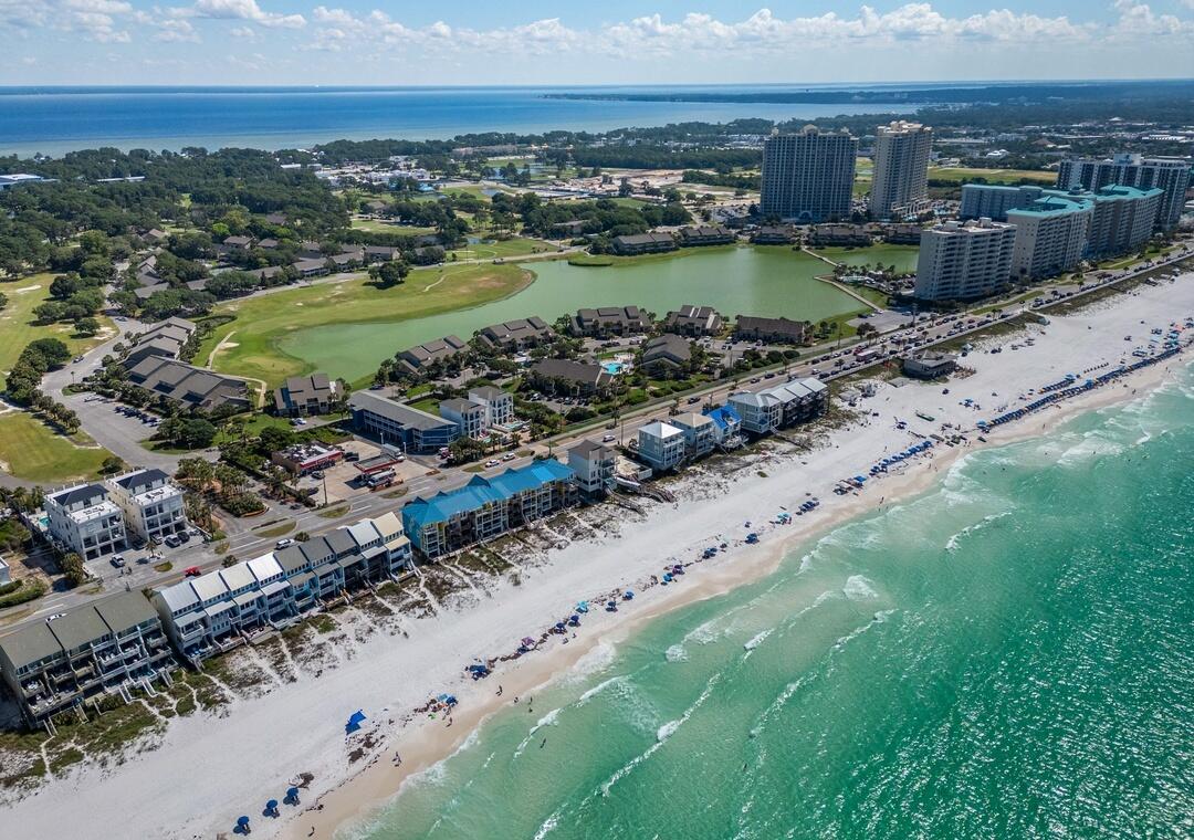 Purchase w/ only 10% down! Welcome to your beautifully remodeled lakefront condo, ideally located within the exclusive, gated Seascape Resort—just 176 yards from the sugar-white sands of the Emerald Coast and offering 2,000 feet of private, deeded beach access. This rare ground-floor unit combines privacy, style, and accessibility in one of Miramar Beach's most sought-after communities.
Enjoy serene lakefront views of Stewart Lake from your screened-in patio, surrounded by lush landscaping and world-class amenities. Inside, the condo has been completely renovated with upscale finishes and thoughtful attention to detail. The stunning kitchen boasts sleek granite countertops, premium stainless steel appliances, custom storybook-white cabinetry with pantry, and an open layout that flows seamlessly into an airy living space ideal for entertaining or unwinding after a day at the beach.

You'll love the luxury tile flooring, updated lighting, and calming coastal color palette that makes the entire condo feel like a true retreat. The spacious master suite offers tranquil lake views and a king-sized bed, while the spa-like bathroom provides comfort and elegance. Additional conveniences include an in-unit washer and dryer and a flexible layout designed to maximize both space and light. Every detail has been thoughtfully consideredincluding entertainment. With TVs in the kitchen, living room, and even on the lakefront screened-in porch, you can enjoy your favorite shows or never miss a playwhether you're cooking, relaxing indoors, or soaking in the view outdoors.

Seascape Resort amenities include:

2,000 feet of private beach access

Five resort-style pools (two seasonally heated)

A golf course

Eight tennis and pickleball courts

Basketball courts

On-site dining at the iconic Whale's Tail Beach Bar & Grill

Proximity to Silver Sands Premium Outlets, Grand Boulevard, and The Village of Baytowne Wharf

Whether you're seeking a personal beach retreat or a turnkey investment opportunity, this lakefront gem offers the perfect blend of luxury, location, and lifestyle. Move-in ready and minutes from everything Miramar Beach has to offer this is your chance to own a piece of paradise on the Emerald Coast.

Qualified buyers can purchase w/ only 10% down.