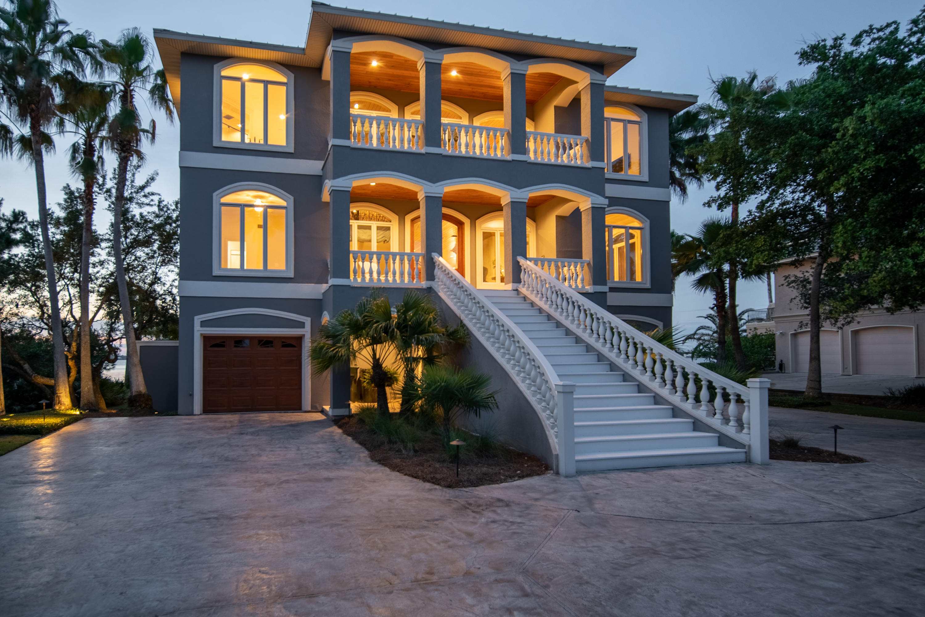 Home of distinction and luxury with the most phenomenal expansive views of Bayou St. John  This newly remodeled 6000+ square foot 5-bedroom 5.5-bath home the exclusive, upscale coastal neighborhood of Ono Harbour offers everything one would want on Ono Island with unbelievable upgrades far beyond what one would expect. Loper Construction built & then refurbished this exquisite home over the last year & the timeless elegance & beauty is truly unmatched. The entry that guides you into the beautifully designed, newly painted residence has been completely redesigned & leads directly into the second floor of the three-story home where you'll enter into an open floor plan with new tile floors throughout, new paint, high-stretching new custom wood ceilings, a custom staircase & retractable chandelier. Main level is ideal for entertaining or simply enjoying island time & features a magnificent great room, new fireplace, & spacious dining room. A chef's kitchen awaits you with freshly painted cabinets, new counter tops, new gas stove, new dishwasher, new refrigerator, new ice maker, & stainless-steel appliances. Watch movies in your own private theatre room with custom Hunter Douglas shades, new air conditioner, new ice maker, & full wet bar for the ultimate cinema experience. Escape to your private master suite on the third floor with a gorgeous new fireplace & updated master bathroom with a soaking tub & separate tiled shower. Additional spacious bedrooms are also on the third floor along with a grand office complete with new ice maker, wine cooler & bar. A guest suite with living space & kitchen on the first-floor lead directly out to the glistening water. Plenty of storage with two climate-controlled rooms in garage. The second parcel across the street on Ono Harbour provides the total package with two liftsa 16-18000lb. boat lift & second lift for your jet skis. Come take a look and start living the Ono lifestyle  a relaxing coastal island community unlike any other.