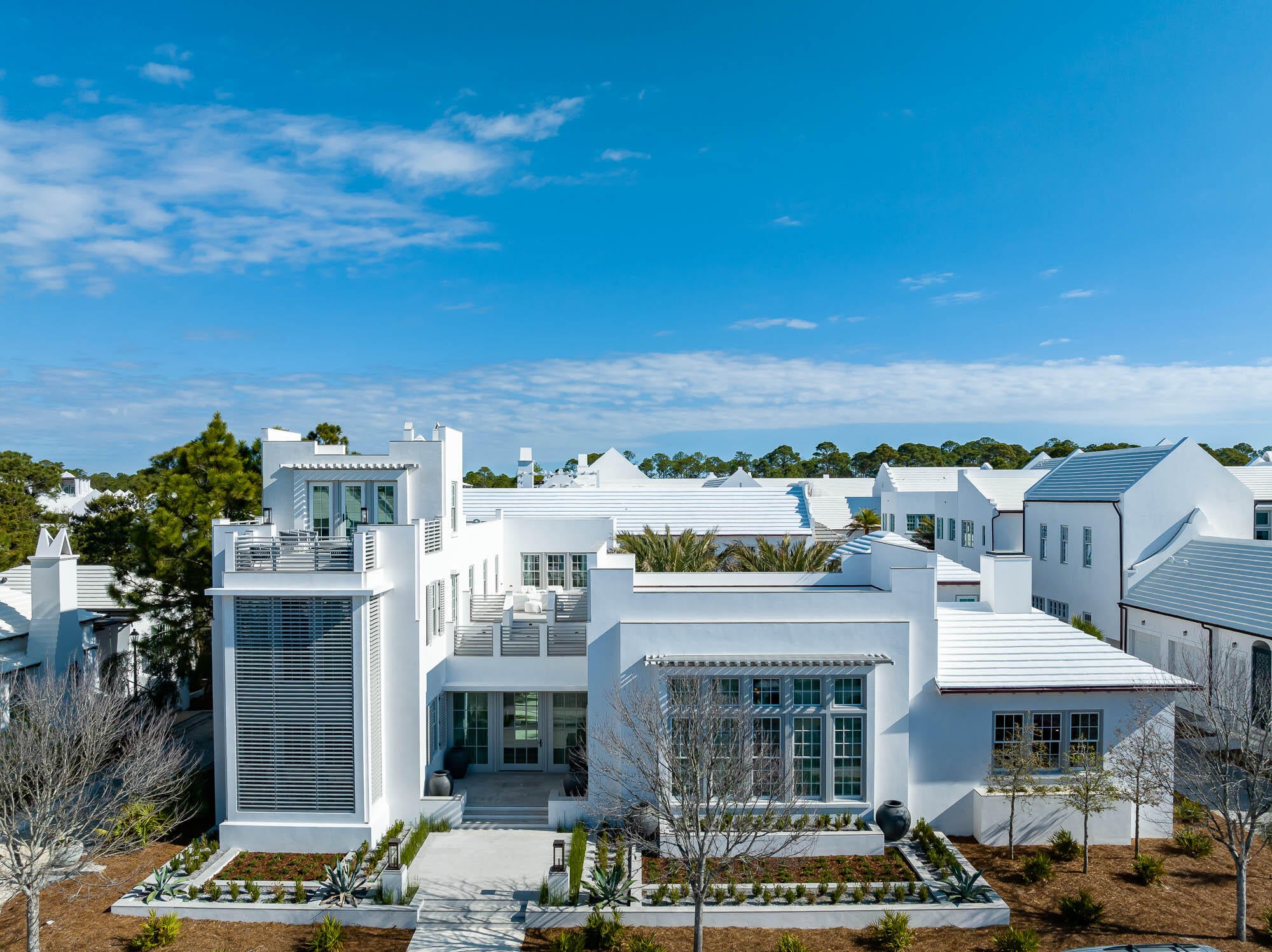Award winning Khoury Vogt Architects does it again with this extremely rare Alys Beach Compound Home that stands alone amongst its peers. 

Fronting McGee Drive, the homes overlooking this street were given special distinction with generous setbacks allowing for first level terraces to give a promenade feel unique to this street alone. 

At 32 McGee Drive, the tone is set with an inviting outdoor entry garden that leads to a sunlit entry hall with offset pivot hinge doors that connect to an oversized Court Loggia. A large great room with concrete floors and integrally colored plastered walls looks out to a Mediterranean courtyard anchored with 4 medjool palms set amongst a sunken seating area and fire pit. A Generous courtyard pool with sunshelf and waterfall fountain is flanked by the first floor master bedroom and the separate carriage house which offers its own private living quarters. An outdoor dining area located just outside the main kitchen is thoughtfully designed with a retractable canopy roof and outdoor summer kitchen. Gaggenau appliances are found throughout. 

Walking amongst the 5,684sf, the interior designs by KVA and the 5 bedrooms, bunk room, multiple media rooms, multiple rooftop terraces, one cannot escape the transcendent feeling that this level of design, thought and execution exudes. It is aspirational... it is inspiring.