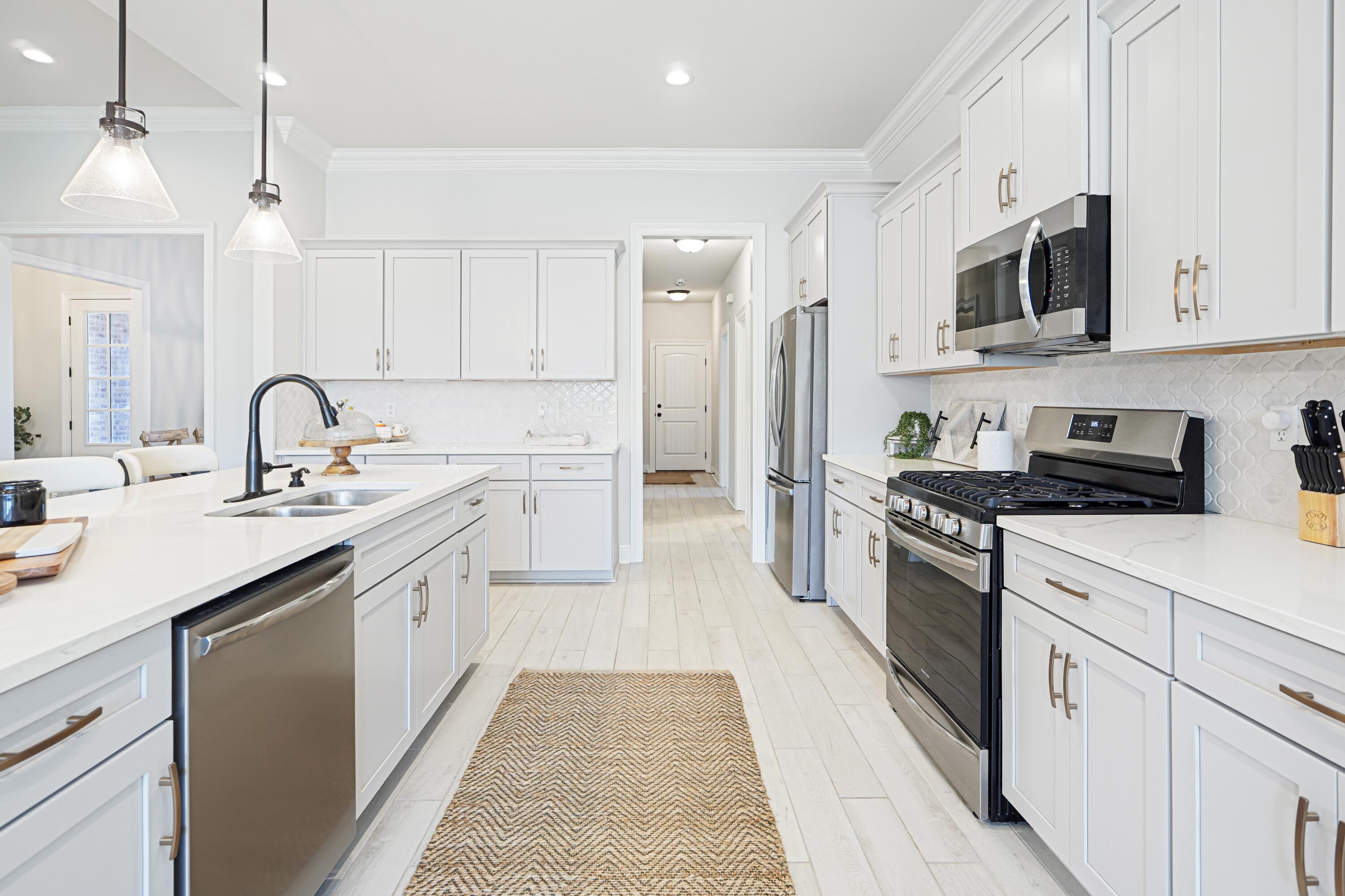 Located in the highly sought-after Hammock Bay community, this beautifully maintained 2022 contemporary home offers the perfect blend of modern comfort and resort-style living. This open-concept gem features a chef's kitchen with gas cooking, quartz counters, a stylish backsplash, and a large island perfect for entertaining. With 4 bedrooms plus a flex space, there's room for everyone with tile throughout. The split floor plan includes two en suites, both with double vanities and the main featuring a spa-like retreat. Enjoy tray ceilings, a grand entry, and a cozy fireplace as the focal point and a beautiful mudroom-style entry from garage. Step outside to a screened lanai with an extended patio pad for relaxing or gatherings. Nestled in sought-after resort-style Hammock Bay.