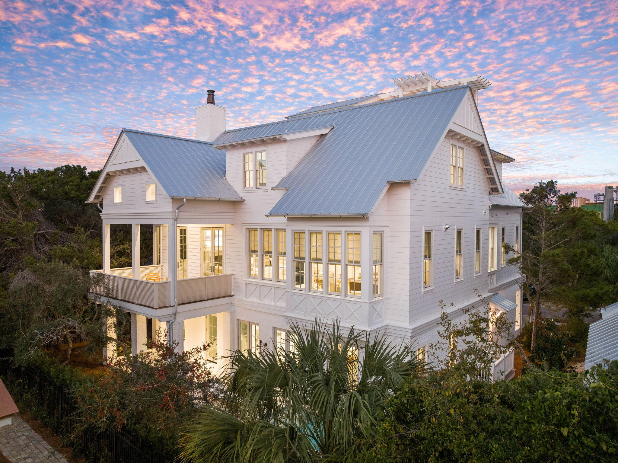 Primely positioned South of 30A and notably designed with striking architectural styling juxtaposed with exquisite interior design, this exceptional legacy property is the newest offering in the gated, gulf front enclave of Heritage Dunes. Thoughtful planning and curated visual & engineering design yields a magnificent coastal retreat comprised of 5 bedroom suites and 5 full & 3 half bathrooms, multiple living areas on each of its impressive four levels as well as a masterful rooftop design featuring an outdoor terrace yielding 180 degree vistas of not only the Gulf of Mexico but also the gorgeous natural foliage of Seagrove Beach. This coastal contemporary masterpiece was beautifully rendered by Burwell & Associates' Gerald Burwell, who partnered with Grand Bay Construction to bring the project to life. 

The ground floor includes two guest bedrooms, both with ensuite baths, a powder room, and a fabulous first level living room that opens directly out to the outdoor pool and private lanai. The home's second floor features a large open-concept gourmet kitchen, complete with side-by-side Sub Zero refrigeration, 48-inch dual fuel 6-burner with infrared griddle Wolf range, and stainless dishwasher. A butler's pantry flanks the kitchen, and offers ample storage options, while an oversized island provides plenty of space for entertaining guests. 

The adjacent dining and living room area were artfully crafted with a lofty ash beamed ceiling. A coquina fireplace and custom designed mantle by Thierry Francois of Francois & Co serve as the focal point for the primary living room area. The soaring cathedral ceiling has a 12' plate height and an impressive 18' vertical limit. If extra space is desired, French doors lead directly onto the second-floor veranda to further extend the living room space. 

The second level also boasts the primary suite, which includes a wine and coffee bar and dual custom-built closets. A spacious walk-in shower and freestanding tub provide a spa-like feel to the space. The third floor incorporates a seating room shared by the two additional guest bedrooms on this level. Both of the third floor bedrooms provide luxury on-suite bathrooms. Upon entering the climate-controlled fourth floor Tower/Sky Bar Room, you are greeted by window-filled walls opening to the trellised lanai which yields unparalleled vistas over the Gulf of Mexico and surrounding foliage. The outdoor space was meticulously designed by architect Patrick Hodges. 

This exquisite space seamlessly integrates the pool scape, outdoor gardens and verandas with the natural environment surrounding the home. The resonant sound of water cascading from separate walls into the southern exposure pool creates a soothing escape. Heritage Dunes offers more than 350 feet of private, monitored beach frontage & access for owners as well as rental restricted privacy and gated entry. The south-side community pool and manicured grounds are added amenities that owners enjoy. 

This prime location is nestled between the new urbanism communities of Seaside and Watersound while providing excellent proximity to world class shopping, dining and entertainment that 30A is so prominently known for.

Reach out to us today for cost to own figures.