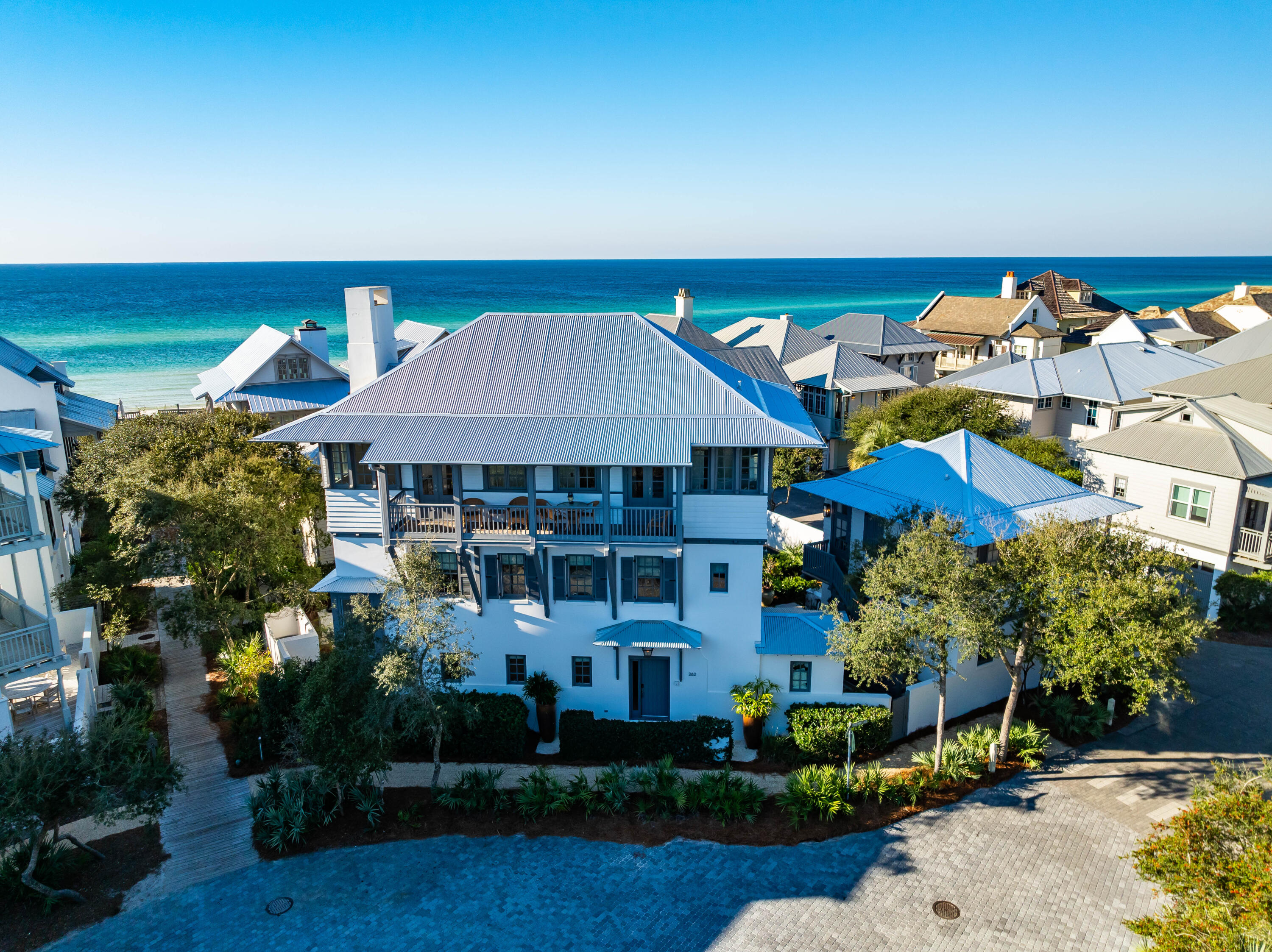 Perfectly positioned on one of the largest lots (5,300 s.f.) in Rosemary Beach, this second row, 4,345 s.f. idyllic coastal retreat, with awesome GULF VIEWS, is located adjacent to walkover A which is the wheelchair and stroller accessible access to the sandy white beaches and emerald-green waters.  Directly across Rosemary Avenue is Rosemary Children's Playground and Park that is shaded with sand flooring so the kids can run and play barefooted when taking a break from the beach making untold memories with their friends, siblings, parents, and grandparents.  

Designed by Eric Watson with curated selections from Tracery Interiors create a unique continuity throughout the home which showcases a mix of natural stone and hardwood floorings, venetian plaster and pecky cypress walls, exposed beam ceilings,  revived with new rugs, chairs, couches, art and refreshed landscaping.  Topped off with a new metal roof and gutters.   

This home's unique beauty is expressed through the rich color palate, construction materials and masterful architectural details.  The primary characteristic is the elevated masonry base which allows porches and outdoor spaces to catch cool ocean breezes.  Details like shuttered windows and doorways, lofty, very high ceilings, steep roof, to shed rainwater and large porches that act as another living space in the home were added to the design making the end result a very uniquely styled home that elevate the coastal aesthetic with familiar and natural materials.  

The full sized Elevator services all three floors.  Two private Guest ensuites sit on opposite wings of the first level with direct access to the resort inspired courtyard oasis with a sparkling salt water pool with sun shelf, water feature and summer kitchen with Lynx grill, ice maker, refrigerator, marble countertops, outdoor shower(s).  Positioned between the two ensuites is the Media lounge for gaming, movies, and quiet time that includes a wet bar.  

The second level Primary suite is adorned with luxurious fabrics, venetian plaster walls, a limestone fireplace, and a lavish ensuite bath with double rail head shower with free-standing tub.  French doors open to the balcony overlooking the pool.  A picturesque bunk room complete with a separate media room and gamer's paradise complete the second level.  

As you enter the living area of the third level you are met with Gulf Views from every corner of the living and kitchen areas that lead out to the full length balcony where you can enjoy ocean views, stunning sunsets, and smell, hear, and feel the wind and ocean.  It doesn't get any better than this in Rosemary Beach!  Anointed with new furnishings, rugs, and art the limestone fireplace is centered for your enjoyment and you'll enjoy the open living space with high beamed ceilings, a customed tufted banquette, and first class kitchen with marble counters, 6-burner Wolf stove, double Thermador ovens, a new Wolf  refrigerator and new Bosch dishwasher.  Sweet!

Attention to detail and functionality was continued to the carriage house that boast of Gulf Views from the porch, separate living area with a Full kitchen, modern cabinetry, hardwood flooring, and private bedroom.

Rental income has been as high as $500K annually with 70+ exemplary reviews.