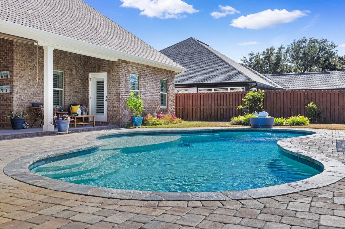 Florida living at its best. Beautiful custom pool home located in the highly desirable gated community of Soundside Shores. This meticulously maintained pet free home is move-in ready. This split floor plan home offers 4 bedrooms, 3 full bathrooms, a private office, formal dining room, breakfast nook, and a living room highlighted by stunning vaulted beamed ceilings. The open gourmet kitchen is a chef's dream featuring a convention oven and microwave, abundant cabinetry, generous storage, breakfast bar, and a walk-in pantry perfect for everyday living. The primary suite showcases a trey ceiling with crown molding and a luxurious spa-style bathroom complete with walk-in shower, soaking tub, dual granite vanities, private water closet, and large walk-in closet attached to the laundry room. Second and third bedrooms share a Jack & Jill bathroom. The private fourth bedroom has a bathroom close by which would make the perfect guest area. Plantation shutters throughout the home add a refined finishing touch. Step outside to a true backyard oasis featuring a gunite pool with reverse osmosis water, a huge covered patio, and a large gazebo with outdoor gas and water hookups-ideal for entertaining. The fully fenced backyard is beautifully landscaped. Additional highlights include a Generac generator and a security system. The Sound and Public boat ramp are a short walk away as well as the Nature Reserve Park. An exceptional home offering luxury and comfort.