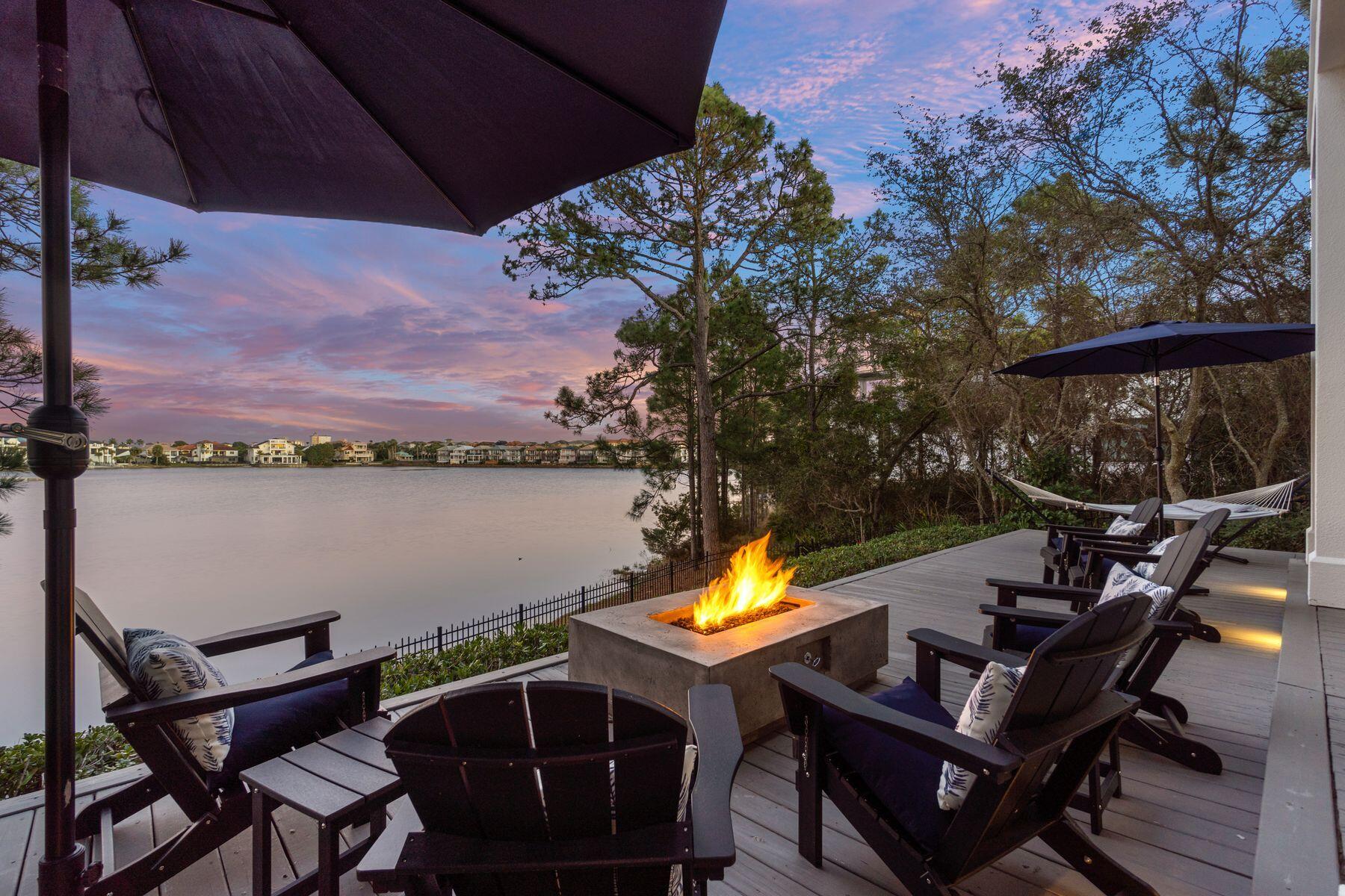 IMPRESSIVE 2026 GROSS RENTAL INCOME in excess of $145K+ & BOOKING! Set within the gated enclave of Destiny West, this exceptional three-story lakefront residence offers a rare blend of refined coastal elegance, thoughtful design, and captivating water views. Ideally suited as a primary residence, second home oasis, or tranquil vacation rental, the property delivers an elevated lifestyle just moments from the sugar-white beaches of Destin.

Upon entry, floor-to-ceiling windows immediately frame serene lake views and flood the open-concept living, dining, and kitchen spaces with natural light. Rich hardwood flooring, custom millwork, and chandeliers establish a sophisticated yet inviting atmosphere throughout. The gourmet kitchen is beautifully appointed with granite countertops, custom cabinetry with ample storage, premium appliances including a gas stove top & wine fridge, and a butler's pantry perfect for both everyday living and entertaining. The adjacent living area, anchored by a gas fireplace and enhanced with motorized window treatments, opens seamlessly to the outdoor living spaces for airy evenings. 

A first-floor bedroom with ensuite bath and walk-in shower offers flexibility for guests or multigenerational living. The second-floor features the primary suite, a private retreat, featuring a spacious wrap-around balcony overlooking the lake, a fire pit for evening relaxation, a spa-inspired bathroom, and a generously sized walk-in closet with custom built-ins. The second guest suite with ensuite bath, walk-in closet, and private balcony is also located on the second-floor. The third level provides a versatile escape with a king bedroom, ensuite bath, and kitchenette ideal as a guest suite, home office, or recreational space. 

Outdoors, the lakefront terrace is a true showpiece, complete with a fire pit, grill, Green Egg smoker, and panoramic water views an ideal setting for sunset gatherings or hosting. Inquire for private pool plans and renderings, offering the opportunity to further enhance both lifestyle and rental performance. The home also features new, durable Polywood outdoor furnishings, a home generator system for added peace of mind, and a garage outfitted with built-ins plus an additional storage room.

Destiny West residents enjoy lushly landscaped grounds, a large seasonally heated pool, hot tub, fitness center, tennis court, and an impressive clubhouse. Quarterly landscaping services are included, allowing for effortless ownership. The home is conveniently located near James Lee Park, the Crab Trap, and pedestrian- and golf-cart-friendly Scenic Highway 98, placing beaches, dining, shopping, and grocery stores just minutes away.

This established vacation rental generated nearly $90K in 2025,  $145K+ already produced in 2026, and the potential to increase income annually with the addition of a private pool. Meticulously maintained and ideally positioned, this lakefront offering represents a rare opportunity to own a premier property in one of Destin's most sought-after gated communities.