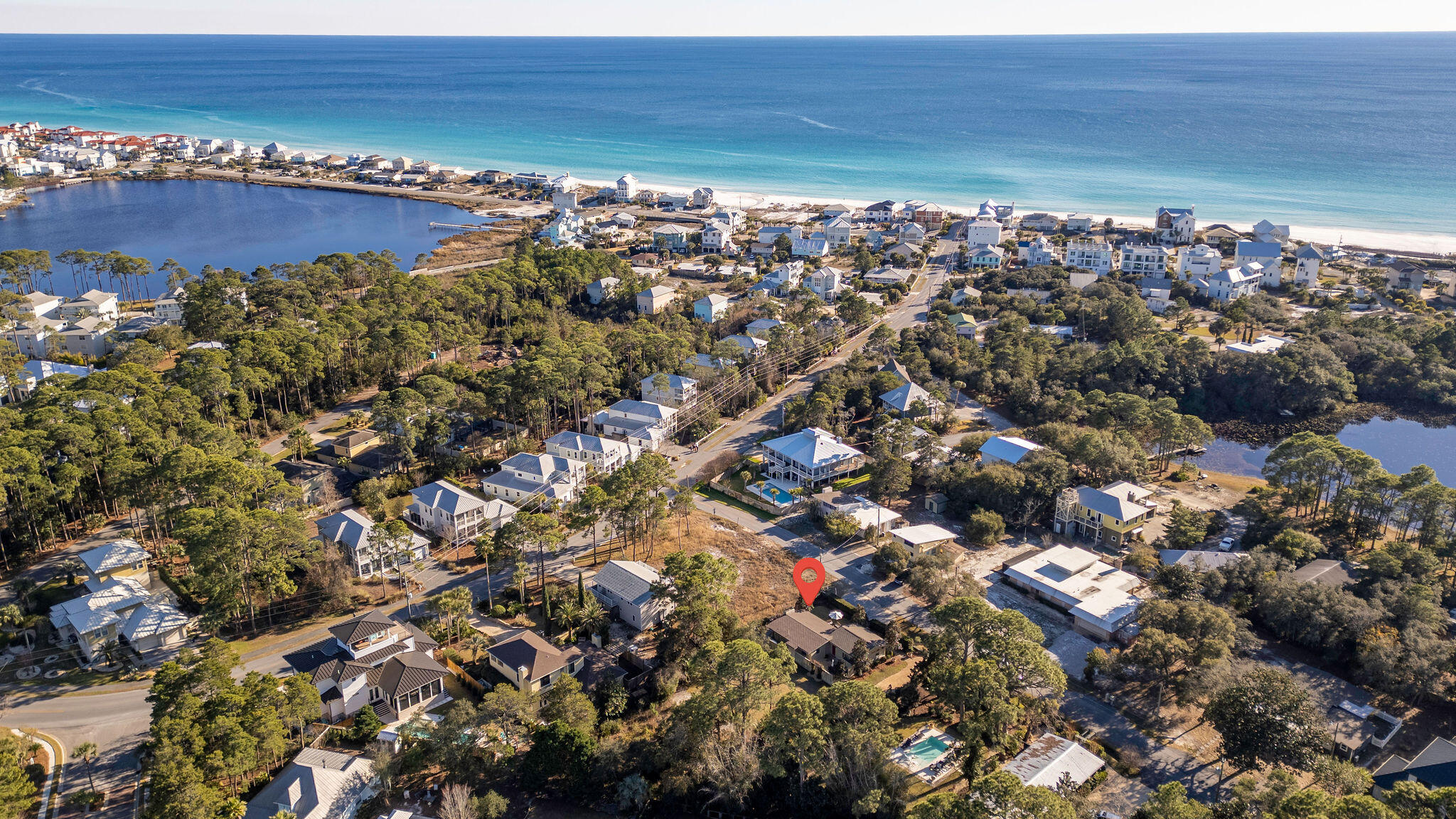 Ideally located at 52 Dolphin Drive in Santa Rosa Beach, this exceptional coastal retreat sits just one block from the sugar-white sands of the Emerald Coast and the public beach entrance offering effortless access to one of Florida's most desirable shorelines. Set on a rare and oversized .51-acre lot with no HOA, the single-story residence spans 1,298 square feet of thoughtfully curated living space that blends relaxed coastal charm with modern comfort. The open-concept living area is warm and inviting, anchored by a gas fireplace and complemented by elegant hard tile and luxury vinyl flooring throughout. The updated kitchen features quartz countertops, stainless steel appliances, and seamless flow for entertaining. Two well-appointed bathrooms include one beautifully updated with quartz countertop, white subway tile.  The other bathroom has cutured marble countertop.  There is a great area off the back patio for entertaining.  Home comes with a whole house Eco Water System and a Generator.  This home is a must see!!!