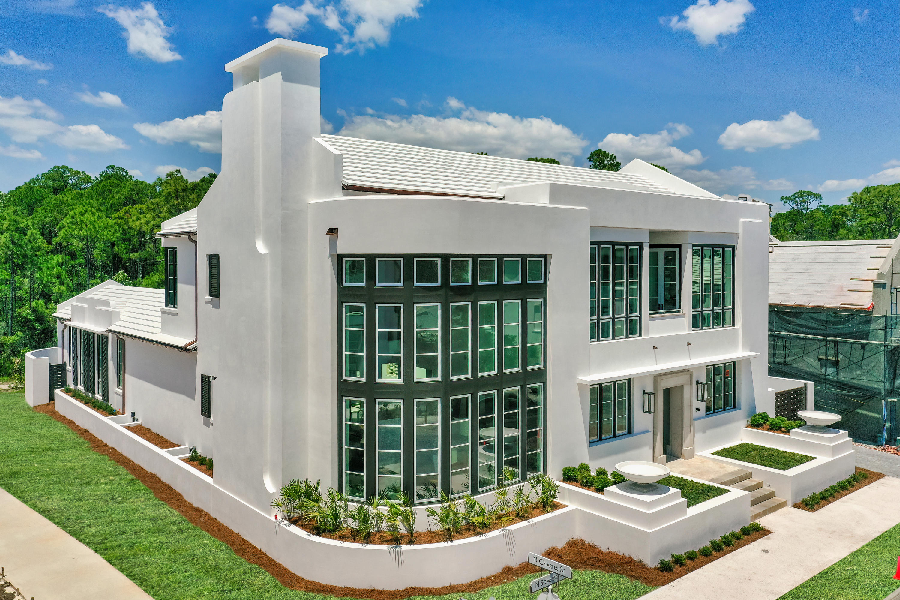 Architecturally inspired and artfully constructed, this turn key new construction offering in Alys Beach is sure to mesmerize all who enter through the custom crafted E.F. San Juan entry doors. Influenced by a blend of Frank Lloyd Wright design ques and a contemporary prominence, this five bedroom 5,050+ square foot courtyard home offers luxurious amenities rarely seen in this desirable 30A community such as a sub-grade dual-fan cooled 600+ bottle wine cellar, a spacious and gated motor court and a private hide-away summer kitchen Outfitted with curated selections such as a full Sub-Zero and Wolf kitchen, Jerusalem shellstone and white oak flooring throughout, custom oak cabinetry, marble countertops and cypress ceiling accents, this awe-inspiring home is truly a work of art. Entry into the home is both dramatic as well as comforting thanks to the floor to ceiling hidden mortar stone wall with steel beamed mantle and fireplace, two story vaulting living space, and a curved wall of windows showcasing plentiful natural light throughout the space. The open concept first floor also features an engaging master suite and a dream-worthy butler's pantry with plumbed espresso maker, wine fridge and custom walk-in pantry for added convenience and truly luxury living. Venetian plaster is seen throughout the walls and ceilings of the entire property allowing light to fancifully dance throughout the home. 

The second story of the main home provides equally mesmerizing features including two guest rooms, each with access to the south facing balcony, as well as a junior master with direct access to an oversized lanai overlooking european inspired gunite plunge pool and sunning deck. An interior juliette balcony provides connected living to the vaulted living space, while designer doors add dimension and character around every turn.

Behind the gates and through the motor court resides an oversized, fully heated and cooled garage with epoxy flooring and a full carriage suite on the second floor, equipped with charming details such as floating shelving in the kitchenette and a reverse tray cypress ceiling design. 

Additional elements designed to make this designer home truly spectacular include custom hardware seen throughout, Kholer Purist plumbing fixtures in all baths, a media closet prewired for surround sound and additional Smart Home opportunities, and a secondary promenade behind the courtyard, currently designed as a zen-garden and pet retreat