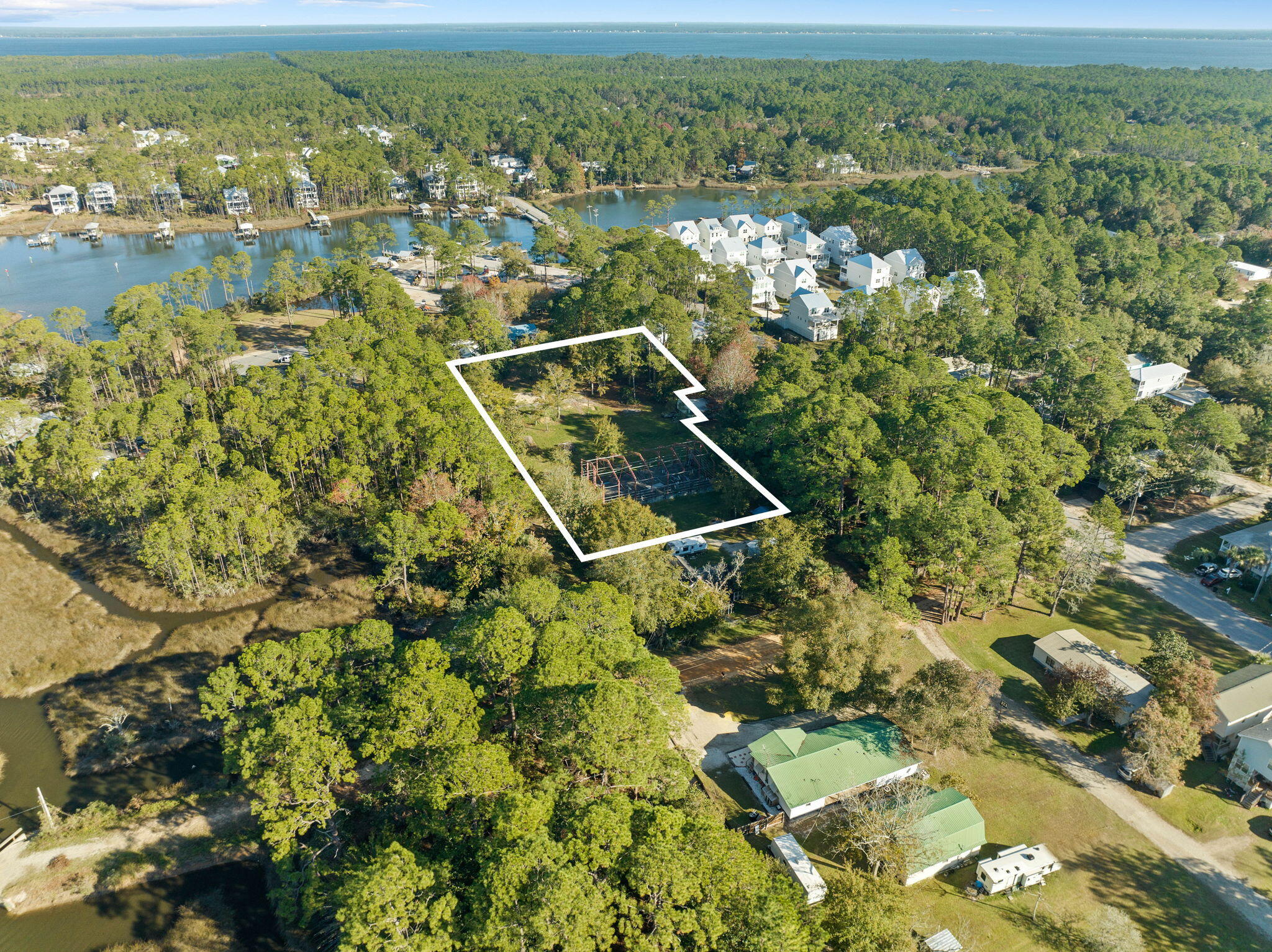 Nestled in the heart of Santa Rosa Beach, this exceptional property features multiple buildable lots, offering prime opportunities for residential development. Free from HOA restrictions, these lots provide a blank slate for creating custom homes that align with modern lifestyles. This rare assembly of lots, with no wetlands, provides the ideal canvas for a visionary development, offering endless possibilities for residential or investment projects in the heart of Santa Rosa Beach. With the area experiencing steady growth and attracting new residents drawn to its natural beauty and convenient location, the appeal of owning and investing in this sought-after area continues to rise. The property does feature a pre-existing concrete foundation and steel framework for a residential home however it was never completed. Permit (# 08-1219) is open and was renewed in 2024. To build multiple lots, buyer would need to subdivide the parcel. Property being sold AS IS. Information contained within this listing such as lot dimensions, is deemed to be accurate but is not guaranteed. Buyer to verify. Additional Parcel available to purchase MLS #: 970729.