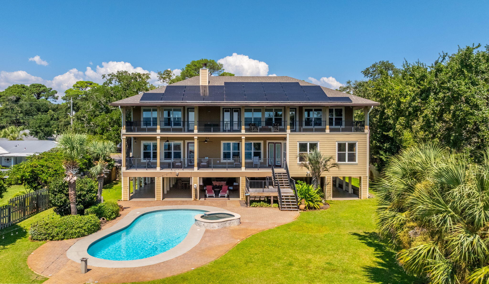 Resort-Style Living on the Intercoastal Sound

This remarkable 6,287 sq ft, 5-bedroom, 6.5-bath estate offers the ultimate lifestyle with 123 feet of deep-water frontage in the sought after Elliott Point neighborhood.

Brand-new 2025 solar panel system with energy savings at just $0.13 per kWh  with a professionally maintained solar and battery system. designed to significantly reduce monthly energy costs while providing reliable backup power during outages. The existing solar agreement (TPO) is fully transferable to the new owner, offering continued energy sustainability, and long-term value and efficiency.

From the moment you step through the double doors,  Soaring beamed ceilings and a sweeping wrought-iron staircase set the stage for timeless elegance. The expansive Great Room features large impact-resistant windows, flooding the space with natural light and showcasing panoramic views of the intercoastal waters.

The chef's kitchen is designed to impress, complete with custom cabinetry, professional-grade Thermador appliances, dual gas ranges, three ovens, a warming drawer, two dishwashers, an ice maker, and 2 beverage coolers perfect for both grand entertaining and day-to-day convenience. Just beyond, oversized waterfront decks extend the living space outdoors, offering the perfect backdrop for dining, relaxing, or taking in the panoramic sound views.

The main-level primary suite is a private sanctuary with breathtaking waterfront views. This expansive retreat features a spa-inspired bath with a large air jet tub, oversized steam shower, and exquisite finishes. His and her dual vanities and two extraordinary walk-in closets, each designed on a grand scale, provide unmatched space and relaxation leading to the large, oversized back porch.

Three of the home's bedrooms are positioned directly on the Intercoastal Sound, each designed as a private master suite with extraordinary water views with the main master being on the main all capturing the stunning waterfront backdrop. A spacious media room also overlooks the Intracoastal Sound, creating the perfect setting for entertainment with a view.

Outdoors, the property is a true retreat with a refinished pool and spa [with new heater in 2024 and 2 new pumps], multiple lounging areas, and a beautifully updated dock. The reinforced pilings, new electrical, and 16,000 lb. boat lift make it ideal for boating enthusiasts. The dock is outfitted with two wave runner lifts perfect for enjoying a full day on the water. 

Beneath the home, you'll find a versatile lower level featuring a spacious garage, large workshop, and full pool bath. Extra storage space is perfect for water toys, tools, and hobbies, while offering effortless access for poolside entertaining. An extra-large motorhome/RV pad with full hookups (water, power, and sewer drain) provides convenient accommodations for large RVs, motorcoaches, or guest vehiclesan exceptional addition for travelers and guests.


Recent upgrades ensure peace of mind and efficiency, including a new roof (2024), 4 complete HVAC replacements [inside and out with UV lights and Dehumidifier] (2021), and a 39-panel solar system with battery backup (2025) under a transferable fixed-rate contract. Additional features include 4 Blink digital security cameras and an irrigation system with a new pump perfect for both grand entertaining and day-to-day convenience. Just beyond, oversized waterfront decks extend the living space outdoors, offering the perfect backdrop for dining, relaxing, or taking in the panoramic sound views.

The main-level primary suite is a private sanctuary with breathtaking waterfront views. This expansive retreat features a spa-inspired bath with a large air jet tub, oversized steam shower, and exquisite finishes. His and her dual vanities and two extraordinary walk-in closets, each designed on a grand scale, provide unmatched space and relaxation leading to the large oversized back porch.

Three of the home's bedrooms are positioned directly on the Intercoastal Sound, each designed as a private master suite with extraordinary water views with the main master being on the main all capturing the stunning waterfront backdrop. A spacious media room also overlooks the Intracoastal Sound, creating the perfect setting for entertainment with a view.

Outdoors, the property is a true retreat with a refinished pool and spa, multiple lounging areas, and a beautifully updated dock. The reinforced pilings, new electrical, and 16,000 lb. boat lift make it ideal for boating enthusiasts. Beneath the home, you'll find a versatile lower level that includes a separate garage, a spacious workshop, and a full pool bath perfect for storing water toys, pursuing hobbies, or enjoying effortless access while entertaining by the pool.

Recent upgrades ensure peace of mind and efficiency, including a new roof (2024), 4 complete HVAC replacement (2021), and a 39-panel solar system with battery backup (2025) under a transferable fixed-rate contract. Additional features include 4 Blink digital security cameras and an irrigation system with a new pump.

With its rare combination of size, luxury, and thoughtful updates, this estate offers the perfect balance of elegance, comfort, and functionality this home is truly a private resort on the water!