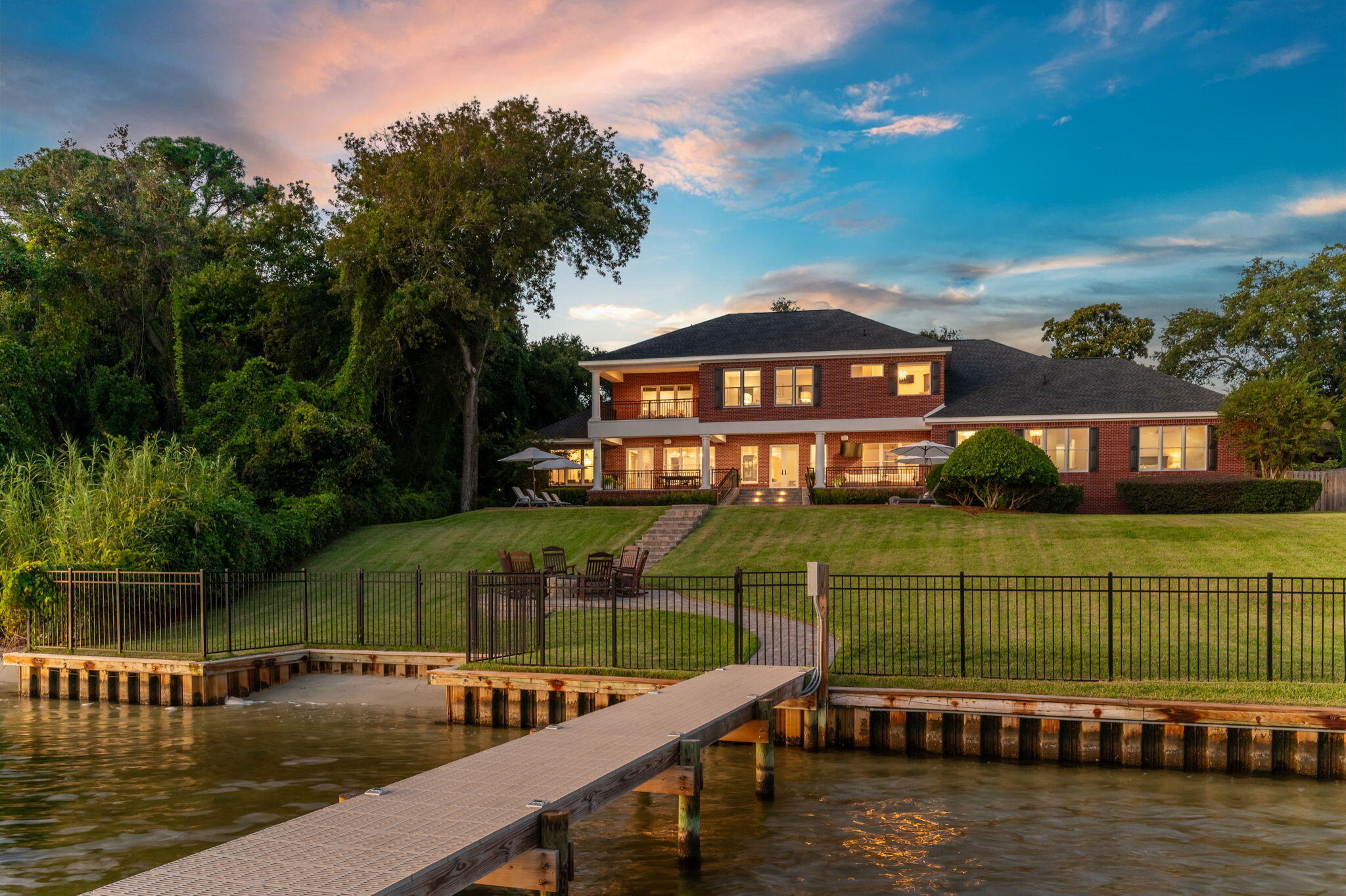 Nestled among a canopy of majestic live oak trees on a sprawling 3/4-acre lot, this custom-built ICF home boasts 144 feet of water frontage on the Santa Rosa Sound & intracoastal waterway. From this prime waterfront location in the Fort Walton Beach area, you'll enjoy stunning sunrises, sunsets, and even glimpses of the Gulf.

Perched atop a bluff in a flood zone X, this energy-efficient ICF home is built to be resilient against mother nature and stand the test of time.  This meticulously crafted home maximizes every inch of space, offering an inviting blend of spaciousness for entertaining and cozy comfort, all while showcasing stunning views of the Santa Rosa Sound from every room. 

This sprawling 7 bedroom, 7.5-bathroom estate spans 7,359 square feet across three separate wings. Each bedroom has their own en suite full bathroom. There are two master suites, one upstairs and one downstairs. Each level is thoughtfully equipped with its own laundry facilities, ensuring convenience and ease in everyday living. The main floor has a   spacious living room as well as a dedicated office space and cozy fireplace den, providing versatile spaces to accommodate all your needs. 

The gourmet chef's kitchen is sure to be the heart of the home, featuring custom cabinetry, a 6-burner Wolf range, and and integrated Sub-Zero refrigerator, all centered around a large island making it the main attraction for family and friends to gather.  Enjoy of the luxury of multiple dining spaces with two designated indoor dining rooms, and the option of entertaining outside on the oversized back patio overlooking the expansive backyard with saltwater pool and serene panoramic views of the "Sound Island Chains," with white sandy beaches and beautiful estuary landscapes. Guest can arrive by land or sea, pulling right up to the deep water dock, featuring a 40,000-pound boat lift, multiple slips, and thru-flow decking. The slips and water around the dock are deeper than most in the area because the intracoastal channel runs alongside the property.  Depths range from 5.9-9.2 feet. In the front of the home, the split 5 car garage and round about pavered driveway ensure storage and parking are never an issue. One of the garage bays is currently being used for a gym. The neighboring lot with pavered driveway is ideal for overflow parking and available for a separate purchase price in addition to the main house. You can keep it for parking and green space or build another single family residence next door. 

Throughout the home you'll want to take advantage of the whole home stereo systems and surround sound.  This home is the perfect blend of modern luxury and casual coastal elegance and it is truly one of the most coveted waterfront locations in the entire Fort Walton Beach area just a 15 minute boat ride from Crab Island and the Destin Harbor, or 10 minutes from the tranquil islands of Navarre Beach. 

All major systems in the home have been updated in recent years. Roof (2023), New 40,000lb boat lift and jet ski lift (2023), New salt water pool equipment (2023), 2 new HVAC units (2023), New water heaters plus so much more. Please reference the additional documents for more info on renovations and age of items.  This home was built using Insulated concrete form (ICF) which has become an elevated standard for high performance residential construction using insulated foam and reinforced concrete blocks to shape of the exterior walls of the home.  This method ensures a sound proof, energy efficient, and natural disaster resistant home which is structurally superior for years to come.

Don't miss this opportunity to make your waterfront dreams a reality!