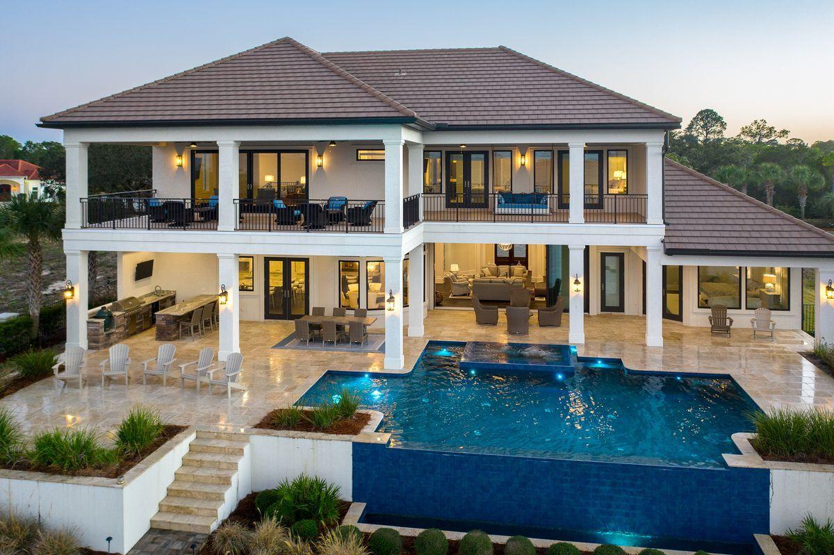 Built in 2017 by Magnolia Custom Homes, this sprawling bay front home is a legacy retreat primely positioned on one of the most premier homesites in the prestigious gated enclave of Regatta Bay. Featuring over 5,735 sqft of heated and cooled living space including over 10,000 sqft under roof and most notably offering a five car garage with 109' of linear frontage on the gorgeous Choctawhatchee Bay. This custom residence was thoughtfully designed and situated on an elevated homesite with notable features including a 30' linear infinity edge pool and spa as well as a spacious rear lanai which enjoys a northwest orientation for soaking in endless summer sunsets. Other notable features include a custom built dock with boat lift and covered boat & jet ski parking as well as an oversized first floor master suite with spa-like ensuite bathroom complete with dual vanities, a walk-in shower, private water closet and two spacious walk-in master closets. Floor to ceiling hurricane impact resistant windows frame the northern exposure of this home allowing sweeping bay vistas from ever portion of the home including the first floor living room which offers 10' glass sliding door for the perfect indoor/outdoor living as well as an adjacent chef's kitchen and custom built bar which is perfect for entertaining and fully equipped with finely appointed finishes including quartz countertops, stainless Thermador appliances as well as a sleek hidden pantry and scullery. The second level offers multiple guest suites with additional oversized heated and cooled storage as well as a secondary bar and entertaining area all overlooking the pristine waters of the Choctawhatchee Bay. Regatta Bay is a gated enclave surrounded by a world class Golf club as well as easy access to Legendary Marina, Whole Foods at the Destin Commons commercial complex as well as easy beach access along the white sand beaches and emerald green waters of the Gulf of Mexico.