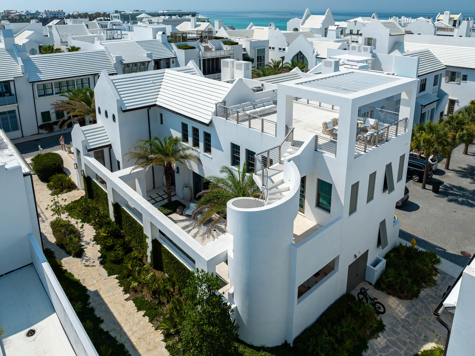 A Boheme Design architectural firm delivers modern living lifestyle to interact with the peacefulness & solitude of the famed Palmera Park.  Located south of 30a, the serenity of the park setting further enhances the homes design and elegance. This stunning property is within close distance to the Gulf Green.  Livability is not questioned with this property.

62 S. Charles Street allows for full-time residency with the generous living aspects the home offers with its 3,845 square feet of conditioned living area and abundance of outdoor living.  This 4-bedroom property consists of 2 primary suites and 2 guest bedrooms, laundry rooms on each floor, a media room with beverage center, and captivating outdoor spaces.  

The kitchen, dining, and living rooms introduce the large courtyard and pool with views through the 30' long multi-slide doors which open to create both spaces as one.  

The outdoor space is an architectural masterpiece showcasing the 32' water wall spilling into the length of the pool flanked by a gas fire pit.  West of the pool is the covered summer kitchen featuring a Wolf grill and Sub-Zero icemaker & refrigerator shadowed by the masterful concrete spiraling staircase leading to the 3rd story roof terrace having Gulf views.  Entertaining is limitless with the abundance of indoor & outdoor living.
 
Each of the primary suites orients to views overlooking Palmera Park.  The 1st floor master suite hosts its own private court with outdoor soaking tub.  Each of the primary suites provides dual vanities, generous showers surrounded by floor to ceiling marble.  Lacava plumbing fixtures for each.  Both primary suites accommodate walk in closets with large multi-slide doors that open to capture breezes and sounds of a still night.  

The 1st floor carries shell stone flooring throughout which continues to the courtyard.  The 2nd floor transitions to Walnut creating a distinctive look while keeping the home's contemporary design.  

Saving the best for last is the magnificent kitchen appointed with a large island aligned to the courtyard views.  This gourmet kitchen boasts a 48" Miele range, Sub-Zero refrigeration, icemaker, and wine cooler. The dining and living are congruent with the kitchen for entertaining.  

12' ceilings carry throughout first floor allowing for the clad floor to ceiling marble surround of the fireplace.    The Control 4 audio & visual system operates the home with ease & simplicity.  

The arrival to the 2nd floor is passed by a Zebra wood clad stair hall with an Italian-made polished stainless-steel railing by Maretti.  Upon arrival to the 2nd floor, you will immediately find the media room with a wet bar featuring the home's 3rd icemaker and beverage refrigerator.  The 2nd floor hosts 2 very generous guest suites with beautifully appointed bathrooms and large closets.   

The private owners Beach Club is available for use upon purchase of this wonderful home.  This property is a must see.