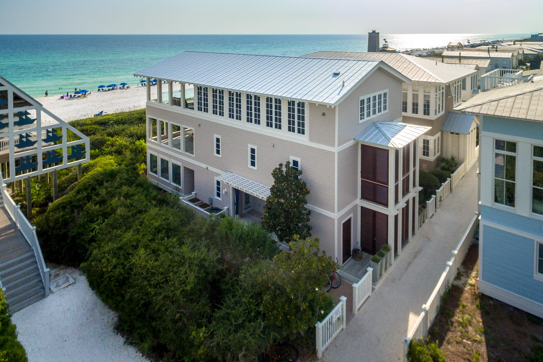 Custom one-of-a-kind and stunning do not come close to describing this Seaside Gulf front home that is truly ''Outside of the Box''. Located on the gulf in Seaside, where New Urbanism was founded, one can enjoy luxury while easily walking to Seaside town center. This beach home offers high-end luxury and has been appreciated by movie stars and prime ministers alike since 2003. Its luxury amenities, include gourmet kitchen, three 20'x 26' gulf front porches, glassed terrace for unobstructed views of the gulf, painted wood plank walls and elevator all define this four bedroom, six and half baths, three story architecturally-acclaimed home. Top of the line finishes include slate floors, stainless steel counter tops, large beamed vaulted ceilings. Exquisitely appointed with a custom-built dining table and an all weather pool table, merely gives one a glimpse into what sets this home apart from its neighbors. The entire first floor is designed for children of all ages. Two bedrooms with four custom built in bunks sleeps eight, four baths, screened porch, all weather pool table and laundry room. The second floor includes two master suites with master baths featuring whirlpool tubs, private balcony, private 20'x 26' porch with gulf views. Third floor boasts a gourmet kitchen the family chef will fall in love with. The entire family can take cooking lessons using family recipes to pass down to generations to come. Island kitchen with seating for five or dine at the custom made table for eight. The finely appointed living room flows onto another 20'x 26' gulf front porch with full view glass panels offering sweeping unobstructed views of the glistening turquoise waters and sugar white sands. Prepare your favorite beverage at the outside bar. A security system, three AC units and hurricane shutters are all mindful components of this home. 2 car carport is deeded with this home.