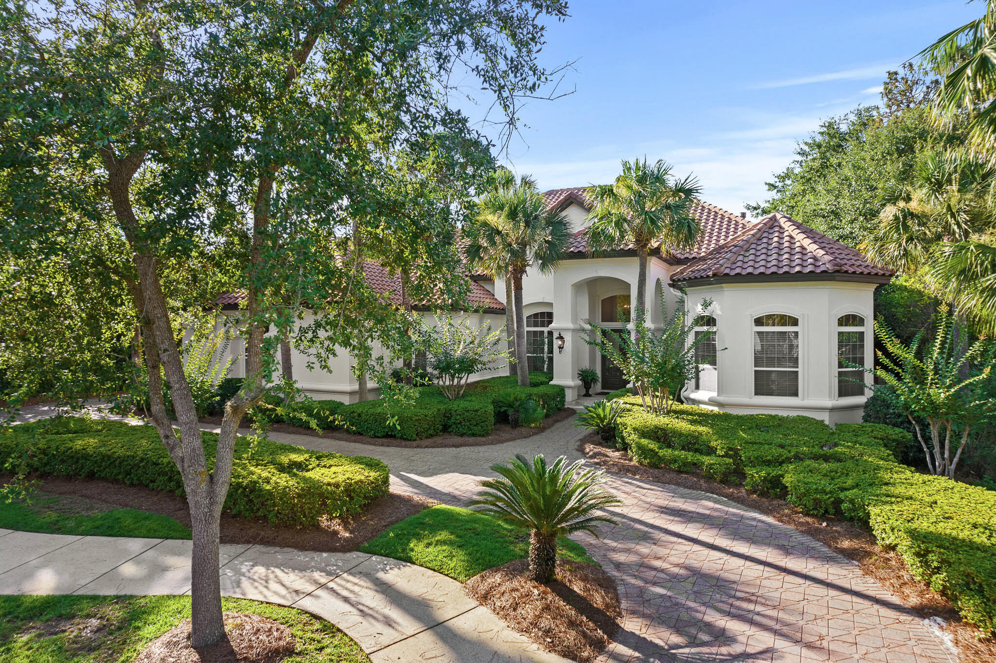 Overlooking the 5th fairway of Burnt Pine beyond the largest lake at the Rees Jones course is this custom built, fully renovated Boswell home. With an open floor plan suited for today's lifestyle, this 4,981 square foot home offers thoughtfully designed and furnished spaces that flow easily for entertaining and an oversized three car garage.  The lakefront location and outdoor swimming pool provide peaceful views through floor to ceiling windows. A full renovation was completed in 2020 reflecting timeless details and finishes in each room.  
The main level features a formal living entrance, formal dining room, custom Wolf-Sub Zero kitchen, spacious master bedroom suite, two guest bedroom suites, laundry room, mud room, and access to the covered outdoor living area and pool with screened enclosure.  The upstairs living space offers complete privacy for guests with a full living area and wet bar, screened balcony, guest bedroom suite with cathedral beamed ceiling and separate nursery.  As a bonus, there is also a stylish movie room upstairs with a Bose sound system.  Other features: antique heart pine wood flooring, marble and stone baths, whole house generator, built-in cabinetry throughout, custom light fixtures, tankless water heaters, custom draperies, exterior paint 2022, outdoor gas fire table., new pool filter and pump, new upstairs A/C in 2019.  Furnishings are negotiable.