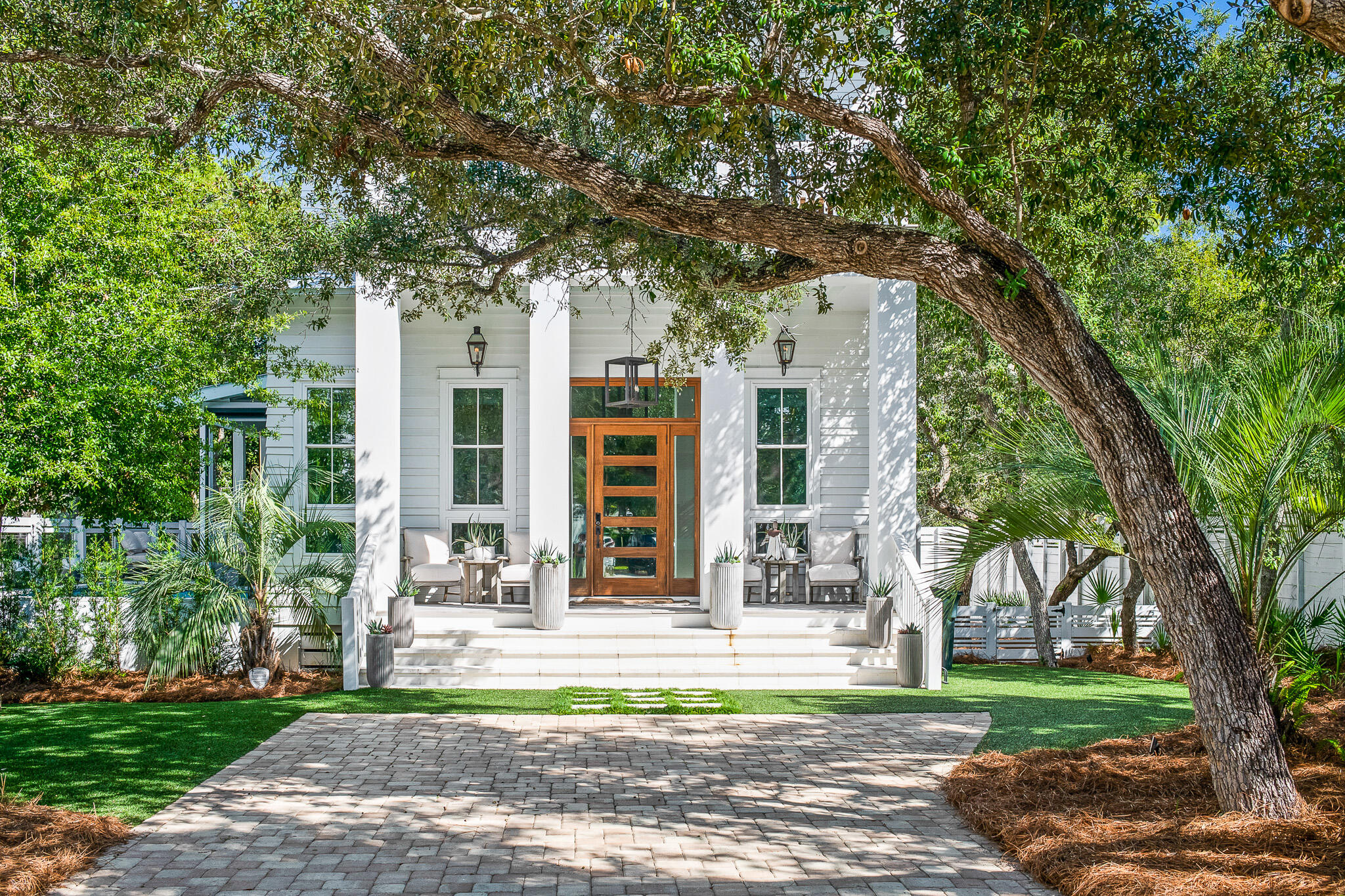 This masterfully crafted residence exudes exemplary coastal charm and is prominently positioned in the heart of Seagrove Beach. With over 3,100 square feet of pristine living space, this 5-bedroom, 4.5 bath home epitomizes 30A living and provides robust short-term rental ability or optimal functionality as a second or primary residence. Desirably situated mere blocks from the beach and presiding over premium canal frontage west of 395, the home has immediate proximity to neighboring Seaside and Watercolor.
	Entering the home, the open floor-plan and double height ceiling exceeding 14' perfectly accentuate the generous proportions and impeccable design in this incredible residence. The first floor features a spacious living room with two seating areas, a linear gas fireplace with floor to ceiling stone surround, antique oak flooring and ample windows allowing for natural light. The large dining area is adjacent to the incredible chef's kitchen complete with high-end Fisher and Paykel appliances, sleek European style cabinetry and a tremendous marble center island, perfect for entertaining. Step out to the expansive and private rear deck surrounded by hundred year old oak and magnolia trees. This amazing resort-style outdoor area features 5 separate hurricane rated Ziptex remote controlled motorized screens, slatted decking, a large pool with laminar jets, an outdoor shower and generous private deck space. Step down to the grilling area and enjoy the tastefully landscaped and spacious back yard with access to the finished under house Gem 4 golf cart garage and storage area. Also found on the first level, a stylish powder room and an over-sized master suite featuring beautiful reclaimed wood architectural accents and a spa-like ensuite bath with a spacious walk-in shower, two separate vanities, a private water closet, and dual closets. 
	Ascending the modern floating staircase with custom designed iron railing leads to the homes's second level. Here you find a convenient full service coffee bar featuring a sink, refrigerator and microwave as well as an adjacent laundry room with additional storage. The second level features a secondary master suite with a stunning vaulted reclaimed oak ceiling. The spa-like ensuite master bath features a beautiful soaking tub, large walk-in shower, marble counter with dual sinks, a separate vanity area, and access to the large walk-in closet. The master suite also features a large south facing covered porch perfect for relaxing and enjoying the sunset. The second level includes a cozy 4-bunk bedroom with coastal contemporary accents. Additionally a third bedroom with 2 built-in bunks includes a beautifully tiled ensuite bath with a dual sink marble vanity.The fifth bedroom suite on the second floor has a gorgeously tiled ensuite bath and access to a screened porch for relaxing while overlooking the serene back yard. 
	Additional notable features of this impeccable home include upgraded interior lighting and fixtures, high-end furnishings and decor, expansive covered porches with tongue and groove ceilings, Glulam structural interior beams, full home automation via Control 4 System, privacy film on 1st and 2nd floor windows, privacy fenced and beautifully landscaped back yard, dramatic front and back yard landscape lighting, Ring 5-camera Security System, and remote-controlled blinds in the living area. This exquisite turn-key home is the ideal residence to enjoy the new urbanism lifestyle with access to shopping, dining, entertainment, and the breathtaking white sand beaches and emerald green waters of the Gulf of Mexico.