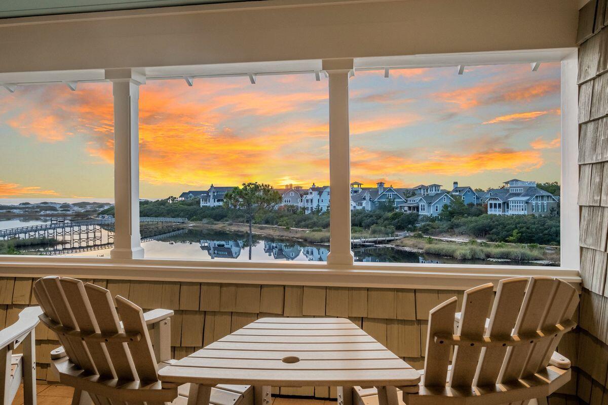 Gulf and lake views abound from this timeless, never-rented retreat in the exclusive, gated community of WaterSound Beach. this custom home was designed by architect Dawn Thurber and Associated and built in 2007 by Coast Life Construction. Offering nearly 2,800 square feet of living space, this coastal masterpiece is replete with high-end finishes including hickory flooring, custom-designed interior doors, a shingled accent wall in the foyer through the stairway, custom-made window treatments, IPE wood decking and 10-ft. ceilings. In the kitchen, you'll enjoy solid maple custom cabinetry with a Dacor range with four burners and Sub-Zero refrigerator. The dining room features cathedral ceilings and the guest bedroom boasts reclaimed antique oak flooring. Notable enhancements to the home include an Electronic Environments audio/visual system, touch lighting, Unico A/C system and two sets of washers/dryers. Ample storage space throughout, including two separate storage areas outside, offer added convenience. Situated lakefront and next to a community dock, this home also offers garage parking and an exterior shower for refreshing after a day spent playing in the crystalline waters of the Gulf of Mexico. An ideal primary residence or vacation retreat, this stunning home has access to all of WaterSound Beach's amenities, including a fitness center, community pools, green spaces, children's and dog parks, seven miles of boardwalks and walking paths, and one full mile of pristine sugar-sand beaches.