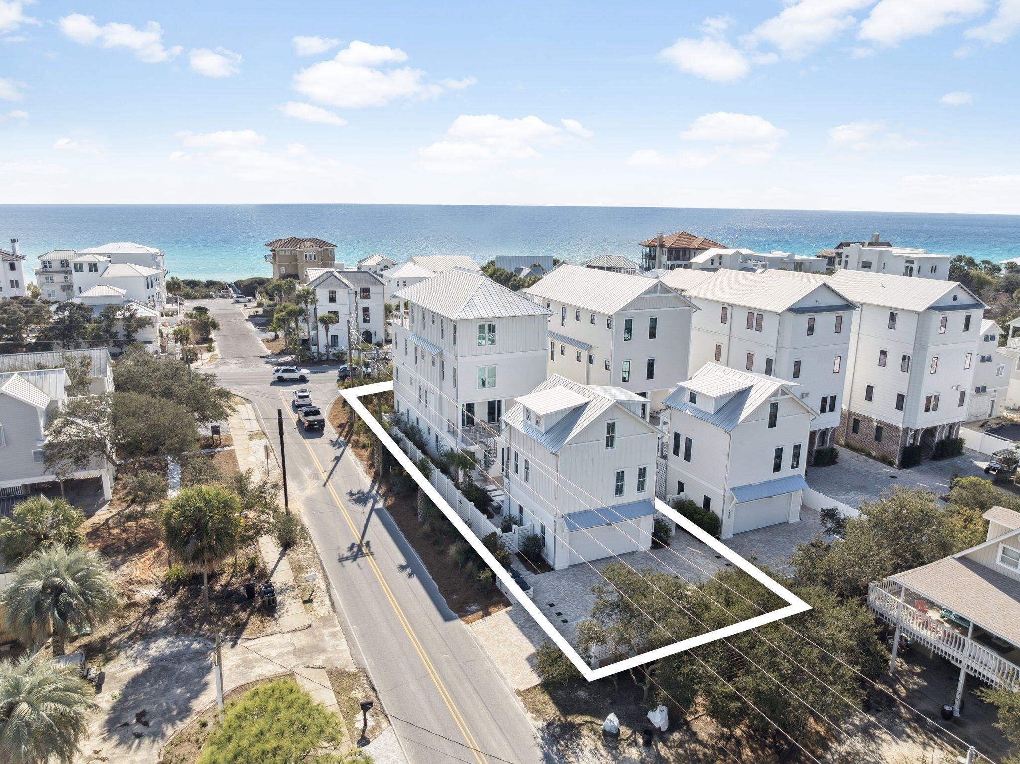 Rare corner lot coastal estate along Scenic Highway 30A, just 100 yards from San Juan Beach Access with Gulf views and a private driveway off San Juan (no backing onto 30A). This approximately 7,215 SF luxury residence spans four levels and offers multiple living areas, a private elevator, and furnished balconies including a fourth floor terrace with panoramic Gulf views.

The home features a gourmet kitchen with premium appliances, and an oversized island, along with designer finishes and coastal inspired interiors throughout. Outdoor living includes a private dip pool and spa (seasonally heated), expansive sundeck, and outdoor grill, ideal for entertaining.

A separate carriage house provides additional accommodations with two bedrooms, full bath, living area, and kitchenette, offering flexibility for guests or multi generational living. Additional highlights include a first floor game room, multiple laundry rooms, ample garage and driveway parking, and a non-HOA setting.

Ideally located minutes from dining, shopping, and entertainment, including a short bike ride to Seaside. An identical neighboring home is also available, creating a rare opportunity for a private coastal compound.