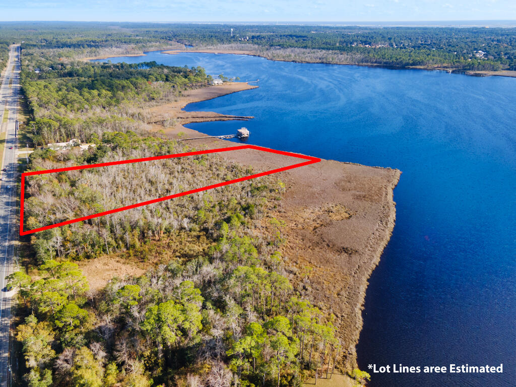 Make these 8 acres of wooded, waterfront property along Hwy 87 in Navarre yours today! Located just minutes from Navarre Beach, and a short drive to I-10 for easy commuting to all surrounding areas and military bases. With no HOA and public water and utility access available out front for you to get connected to and build your waterfront getaway, your own private fishing hole, or just your very own spot to catch the sunsets on the bay!