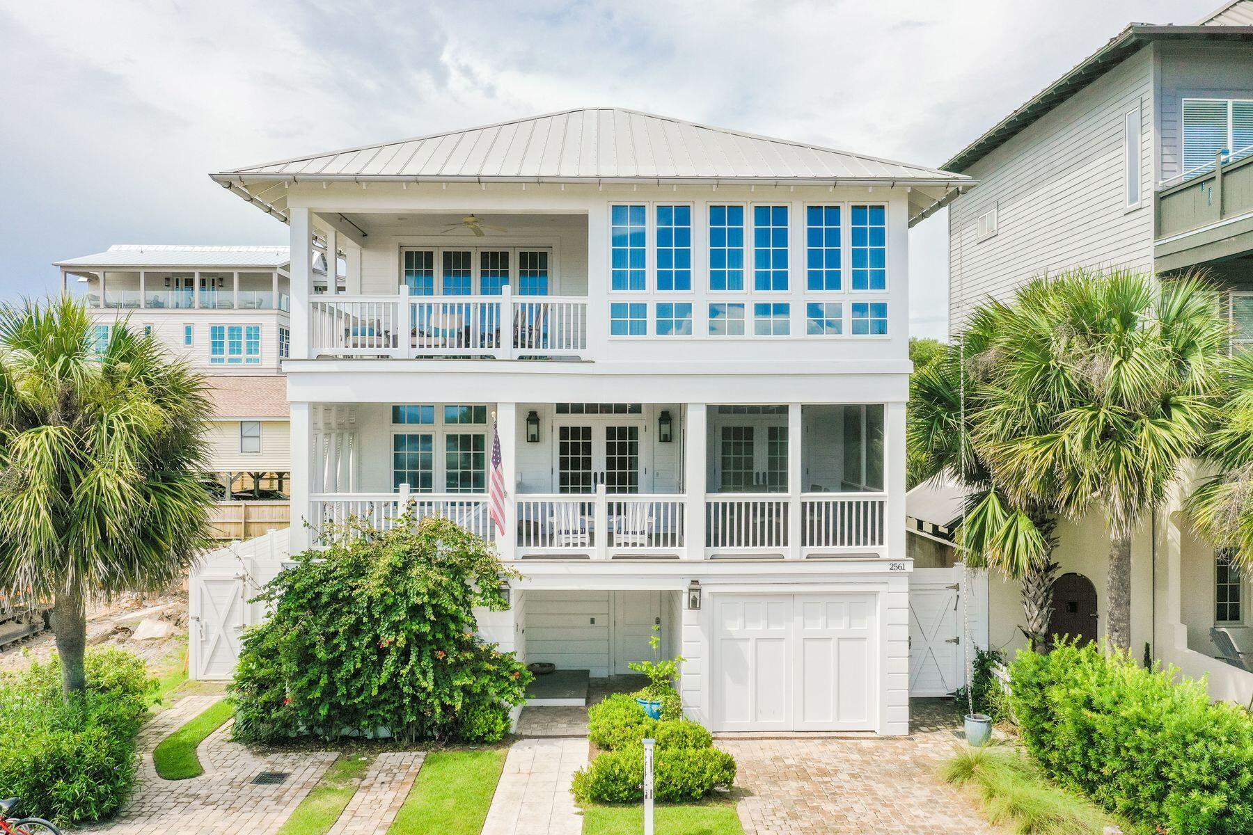 This magnificent beach home is one house from the beach with amazing views and an incredible outdoor living area with pool, spa, and lanai for the entertaining lifestyle. Steps from the white sandy beach, this prime located three-story home boasts breathtaking gulf views. This spectacular house was designed by renowned architect Sheldon Stone and interior designer Parker Kennedy in 2015. Four well-proportioned living spaces provide ample space for entertaining in style while guests can seek out their own quiet nook to relax or chat. White shiplap and soft nautical hues create a laid-back beachy ambience in a home designed for families and friends to come together and make memories. Floor-to-ceiling french windows bathe the main living area in natural light while gleaming hardwood floors floors add a sense of timeless durability. Entertaining is a cinch in the fully-equipped open-plan kitchen with all-white cabinets and granite counters. The center island breakfast bar is designed for hanging out with the chef. A sliding barn door hides ample orderly storage in the spacious walk-in pantry. Five upscale bathrooms and five bedrooms include a spacious bunk room. Wake up to shimmering gulf views stretching to the horizon from several porches and loggia. Step outdoors and enjoy Florida life to the full. Relax on lounge chairs beneath the gazebo and take cooling dips in the curving saltwater pool and hot tub. Life at the beach does not come more convenient, with a beach walkover directly across the street. Look forward to solitary early morning walks on the expansive wave-lapped sand and sharing stunning sunsets with those you love. Boutiques, al fresco dining and entertainment are plentiful in nearby Seaside.